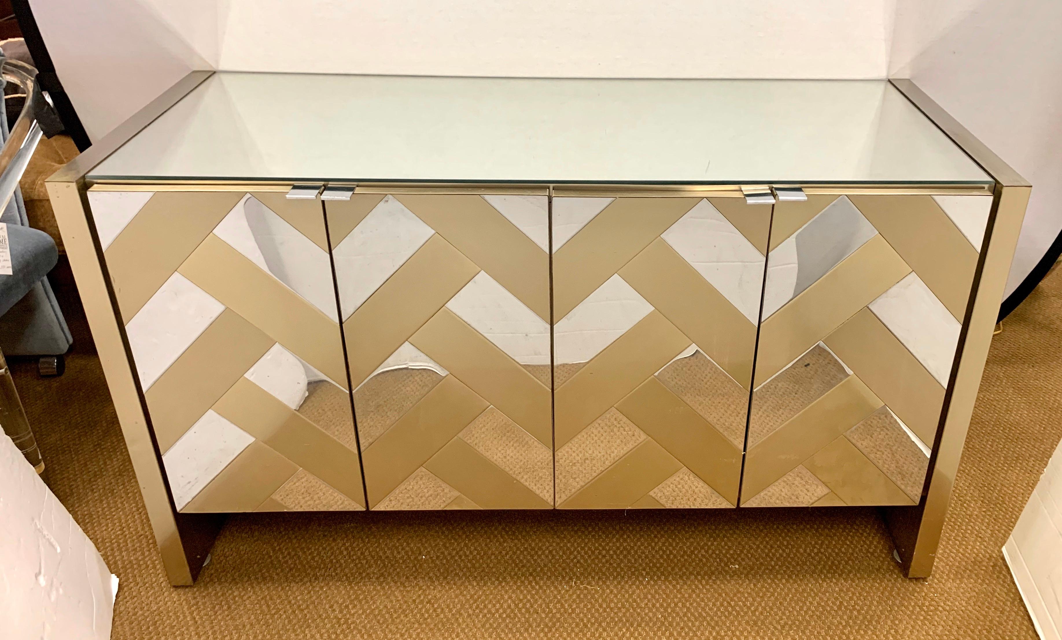 In the style of Paul Evans Cityscape, this iconic Ello midcentury mirrored glass and chrome server/credenza is as sleek as it looks in the pictures, and has just the right scale. There are four doors at front which open to show two drawers at top