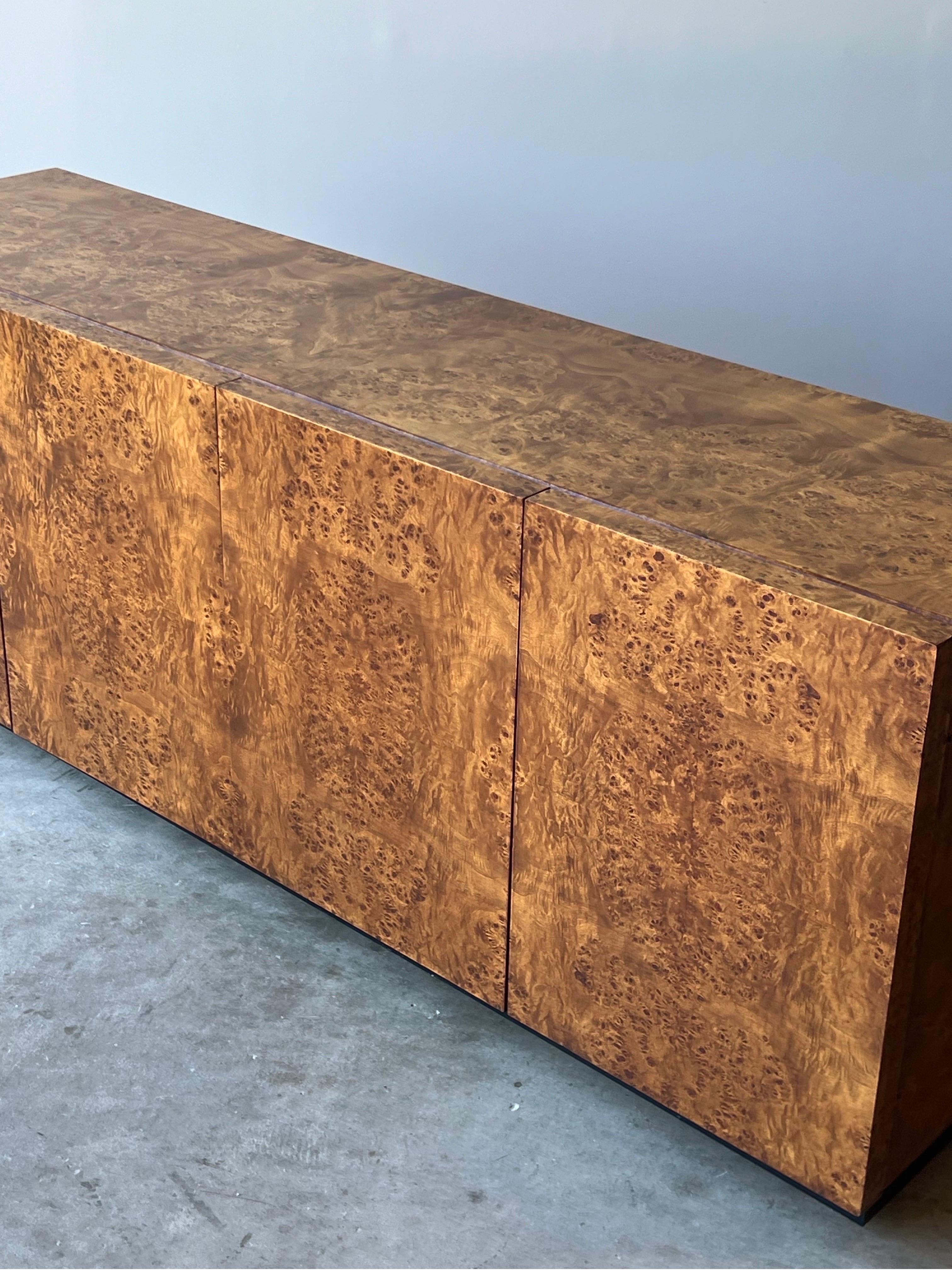Mid-century burl wood credenza or sideboard. This stunner was made by Dillingham in the style of Milo Baughman. It’s not often we offer burl wood items and if we had a bigger house, this one would be coming home with us. This gorgeous piece has four