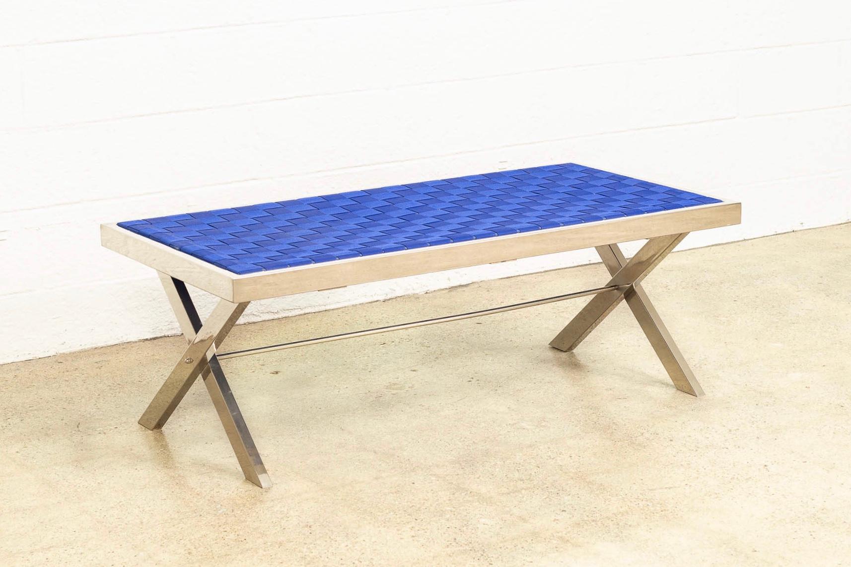 This vintage Mid-Century Modern Milo Baughman style chrome and strap bench is circa 1980. The clean, Minimalist design features a chrome frame with crossed X-base and a woven heavy strap seat in a striking shade of royal blue. Use as a seat bench or