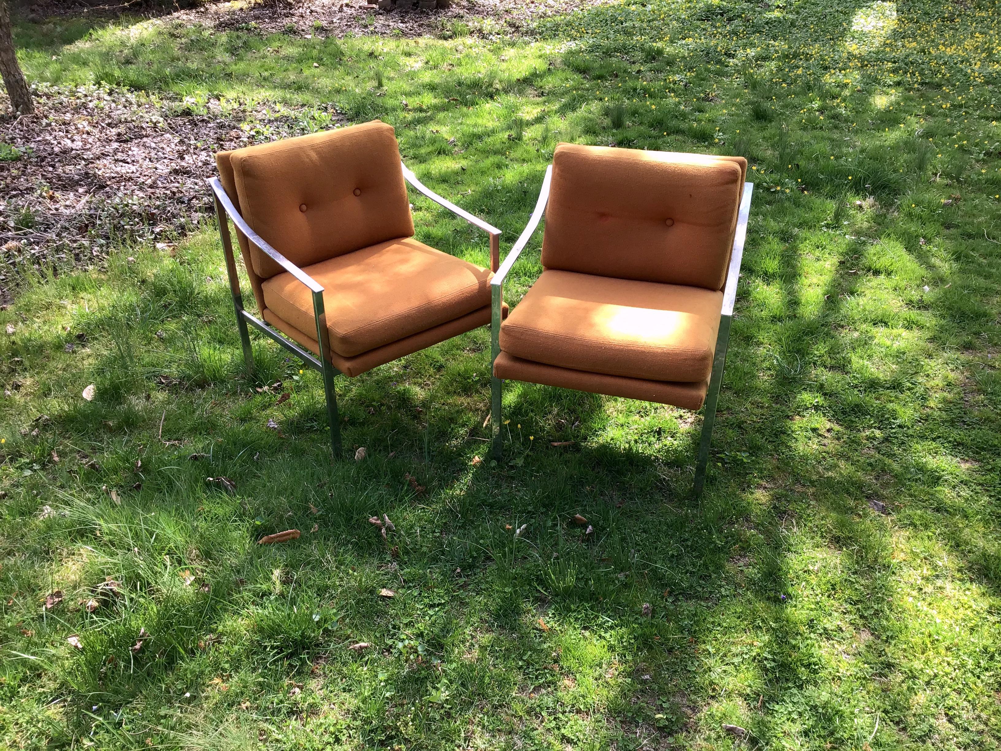 A pair of mid century Milo Baughman style chairs in chrome with original orange fabric upholstery.
 