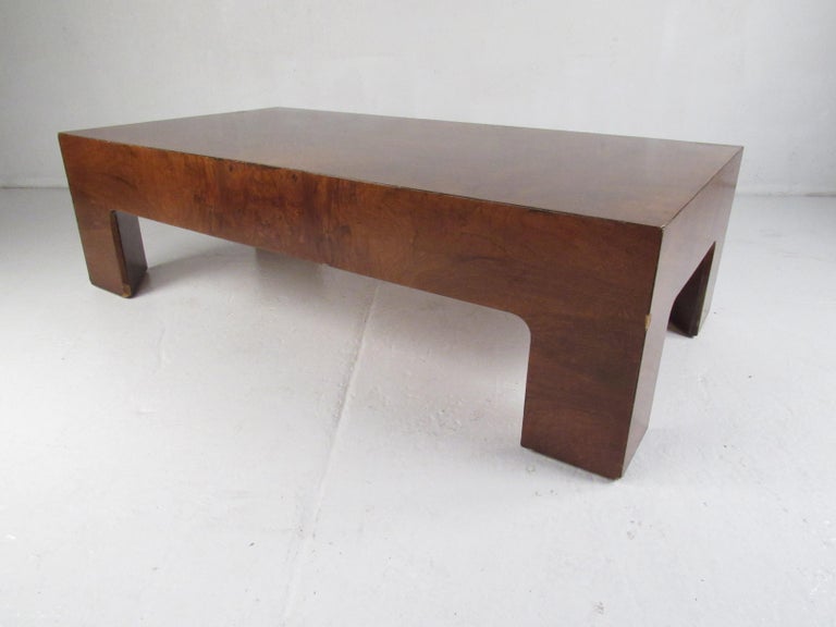 A beautiful vintage modern burl coffee table designed in the style of Milo Baughman. A convenient rectangular design with gorgeous wood grain throughout. This unique low cocktail table makes the perfect eye-catching addition to any home, business,