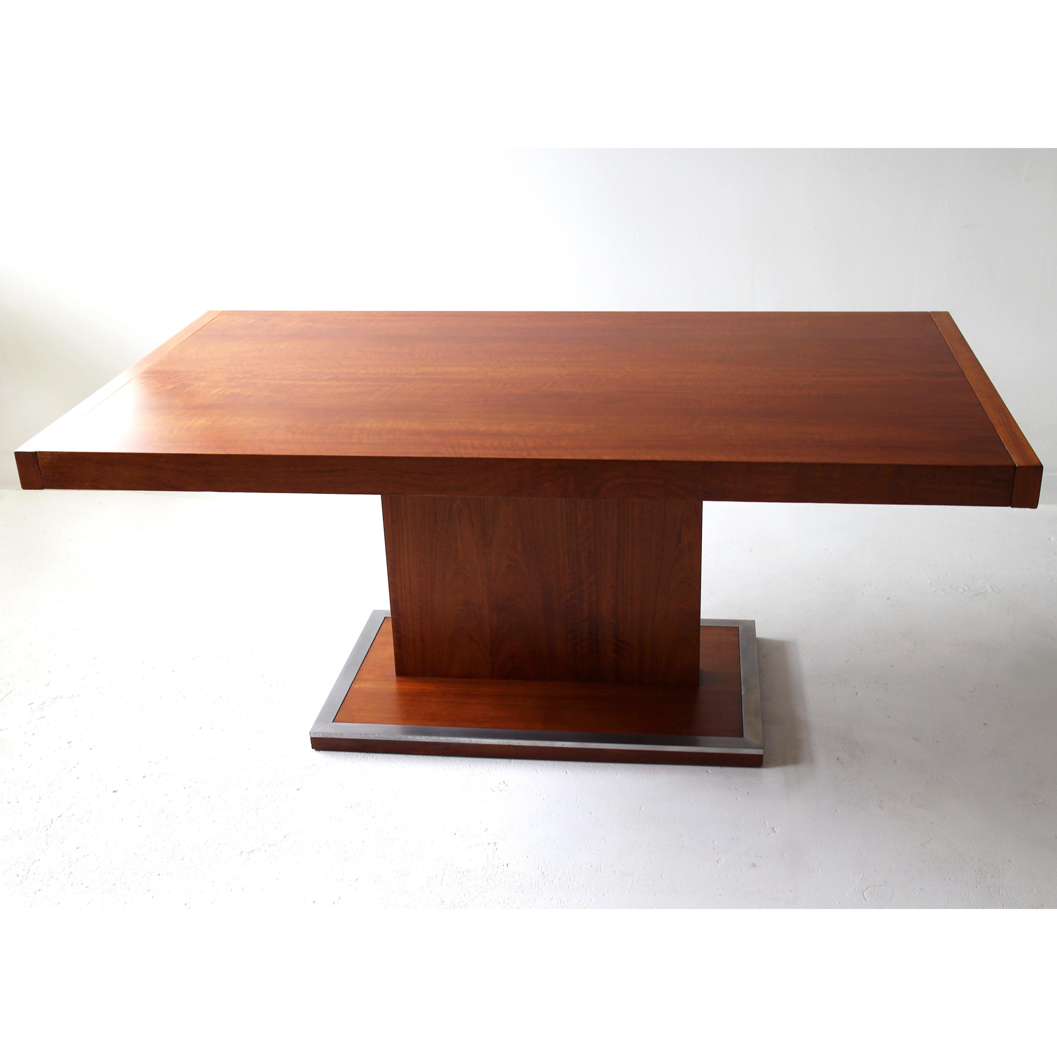 This original Mid-Century Milo Baughman expandable walnut dining table by Founders Furniture Company is a rare find. Only one previous owner, in great condition with polished aluminum edged pedestal base and 2pc additional leaves. The table has been