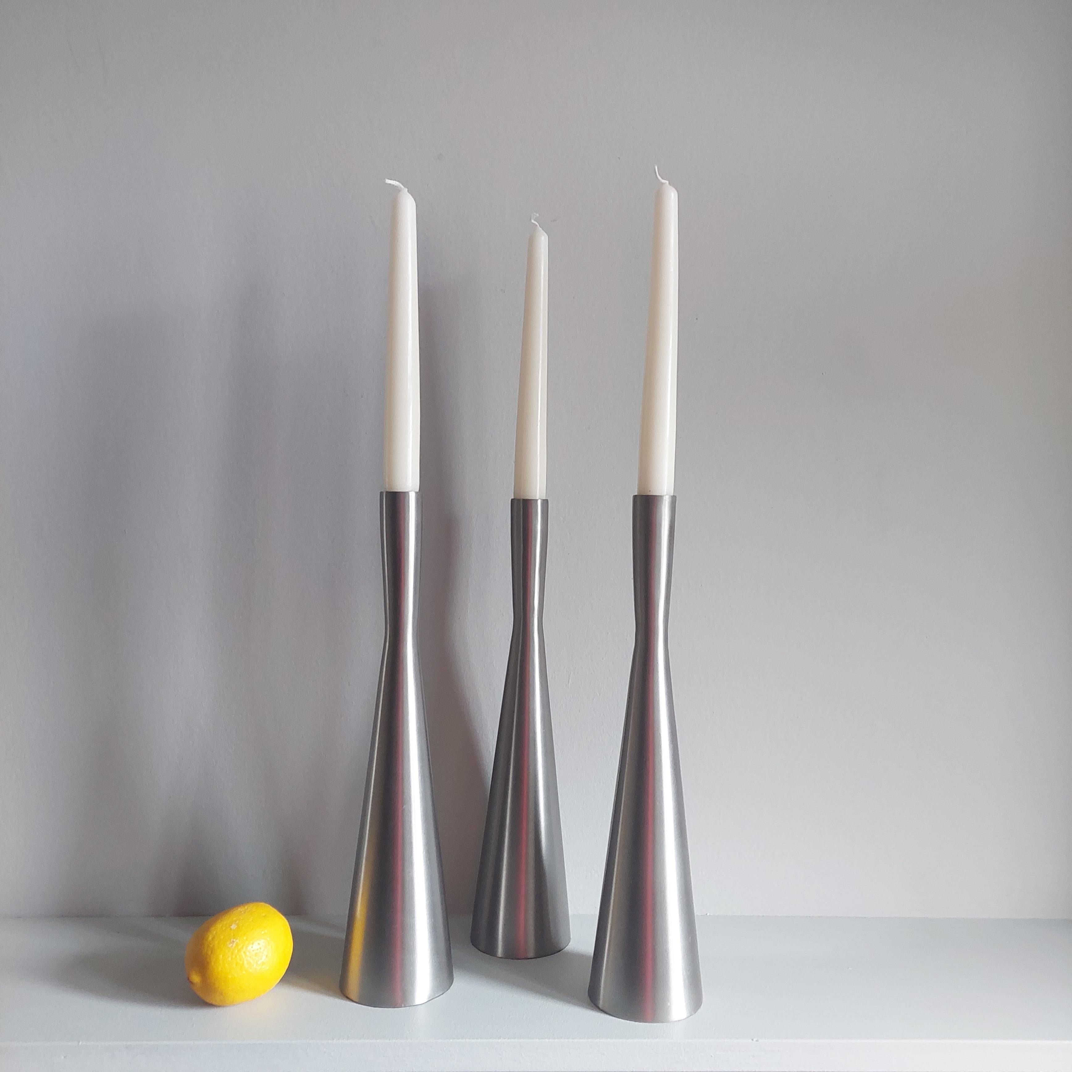 Fantastic set of 3 post modern candlesticks 
Circa 1970s

Made from brushed aluminum.
The minimalist design will sit well on any table or sideboard. 
Priced as trio.

It has a nice conical shape in its lower part, while the last upper tercei is