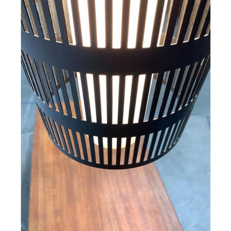 Simple glass pendant lamp with perforated metal diffuser.

The lamp consists of two elements. A glass cylinder inside and the outer diffuser made of perforated metal. The glass is connected to the frame and the suspension of the lamp via three