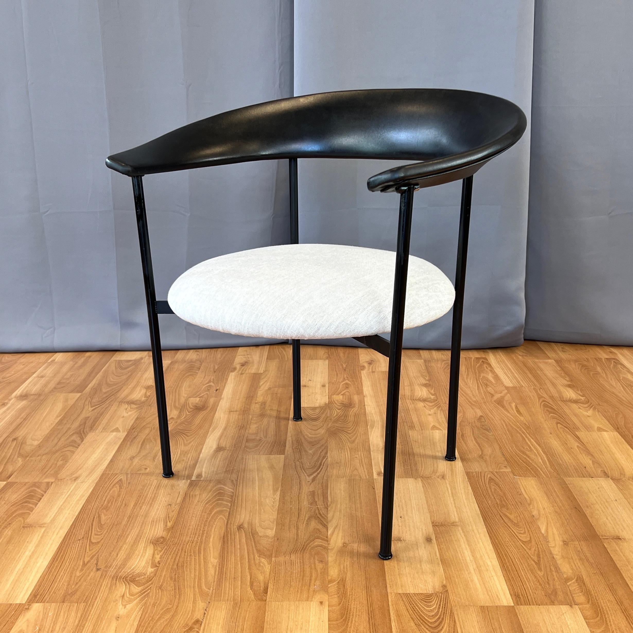An uncommon and visually commanding yet minimalist 1960s Danish armchair with sculptural back, large round seat, and black steel rod frame that looks fantastic from every angle.

Notable for its eye-catching integrated back and arm rest that