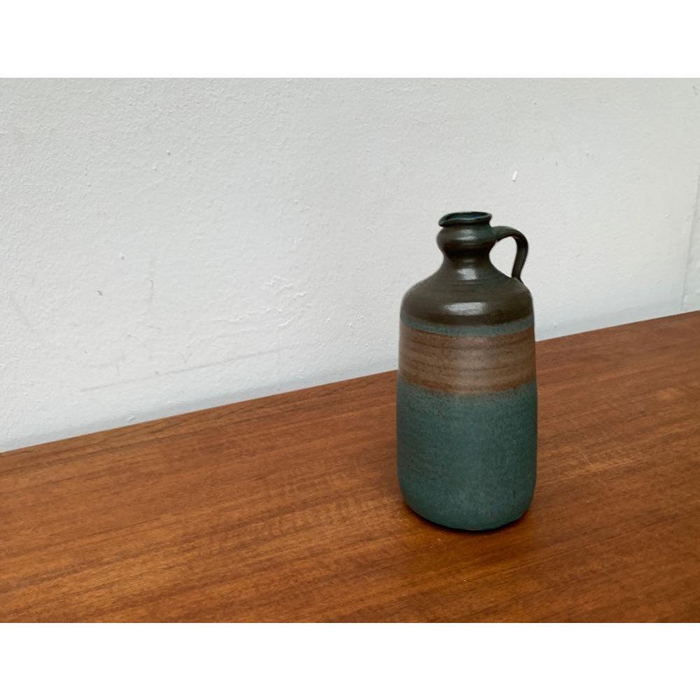 Mid-Century Minimalist Studio Pottery Carafe Vase, 1960s, in Very Good conditions. Designed 1960 to 1969.

Additional information:
Materials: Ceramic
Styles: Minimalist
Color: Brown
Item Type: Vintage, Antique or Pre-owned
Dimensions: 3.94ʺW ×