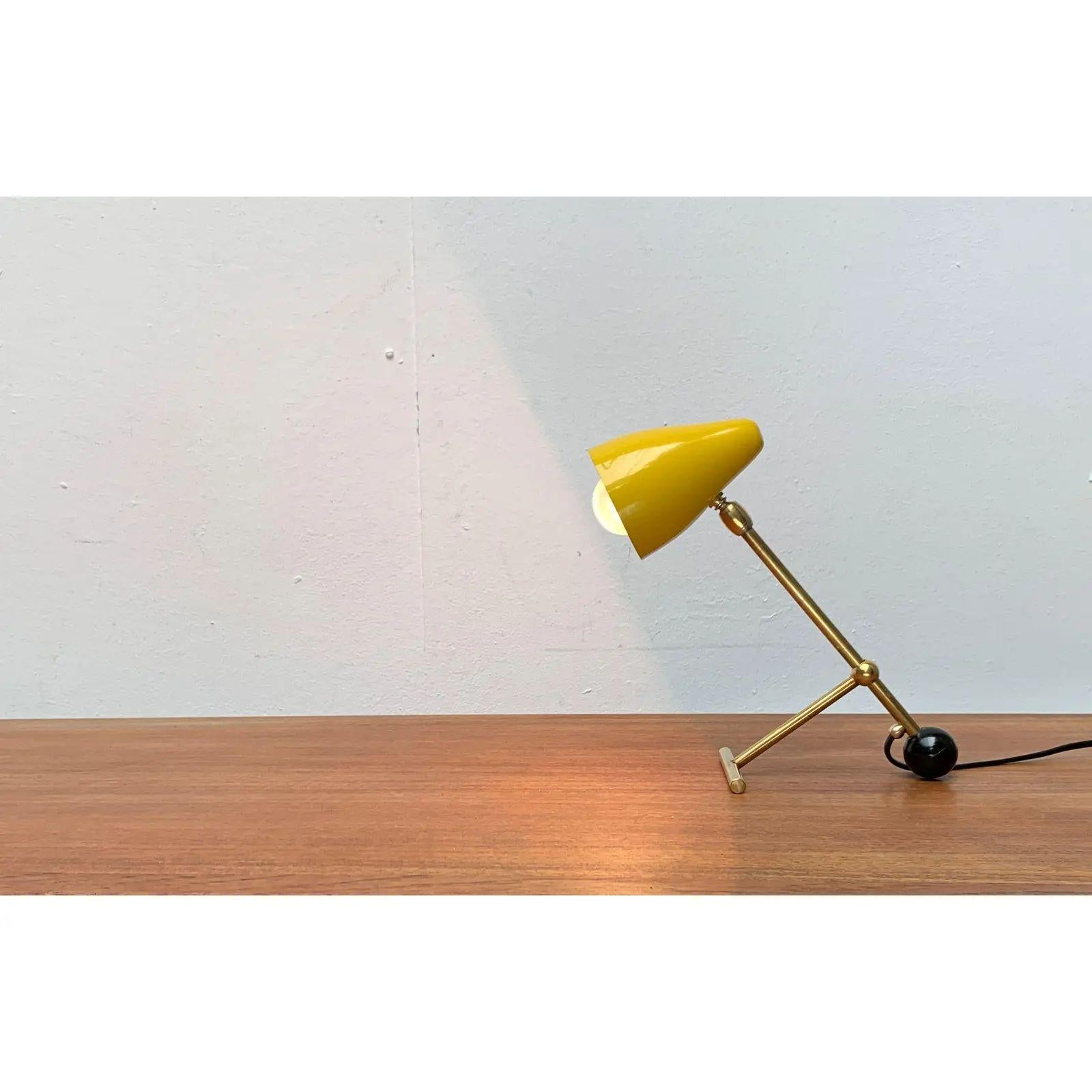 Small mid century table lamp of French origin.

The lamp is reminiscent of Jean Boris Lacroix's designs from the 1950s. The umbrella is designed in yellow and adjustable via a joint. The peculiarity of this lamp lies in the simple system for