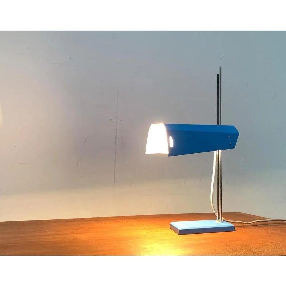 Mid-Century table lamp from Lidokov after a design by Josef Hurka from the early 1960s.

A minimalist design with a cubist, technical formal language. The chrome -colored shaft is particularly finely carried out and is divided into two rods of