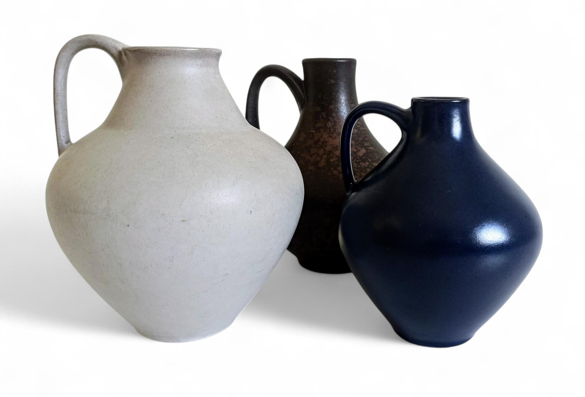 Set of Three Mid-Century Minimalist Handled Vases by Fritz Van Daalen, Germany, 1930s
An exquisite set of three Mid-Century Minimalist vases, designed by Fritz Van Daalen, founder and first designer of the prestigious Van Daalen ceramics studio,