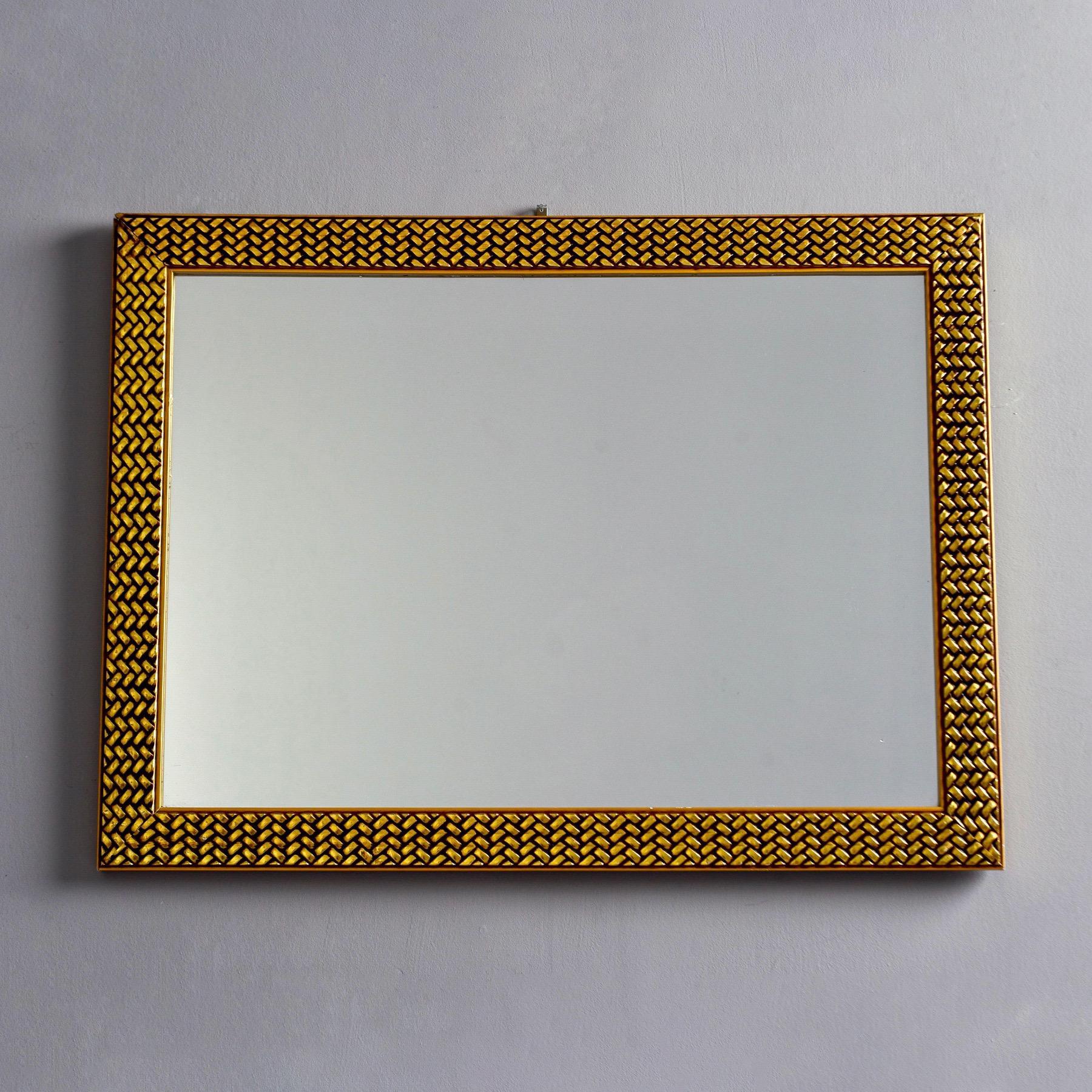 Found in France, this circa 1970s rectangular mirror has a basket weave textured frame and brass-like finish. Unknown maker. Wired to hang vertically or horizontally. 

Actual mirror size: 18.5” high x 27” wide.
  