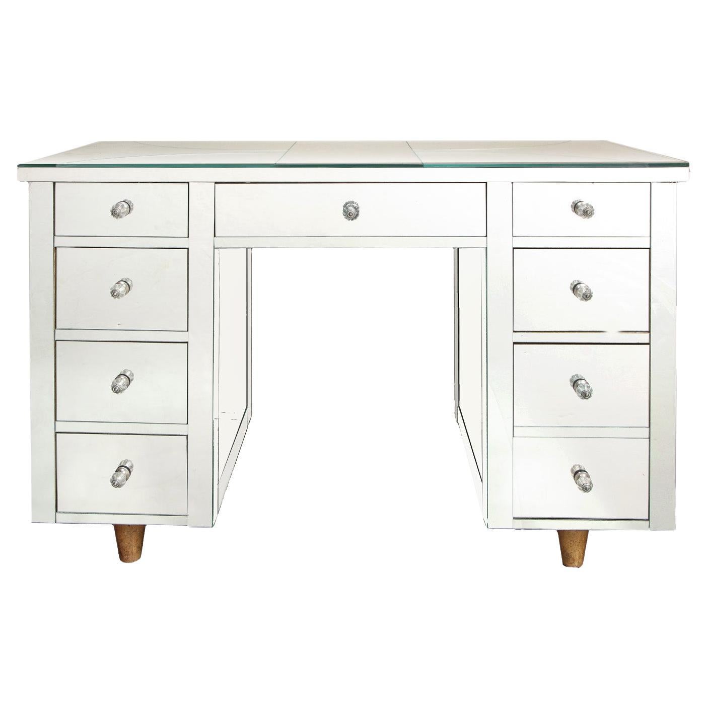 Artisan nine drawer mirrored desk with star motif and conical blond wood legs. American, 1950's