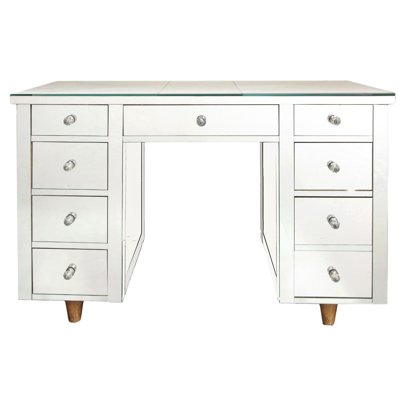 Artisan nine drawer mirrored desk with star motif and conical blond wood legs. American, 1950's