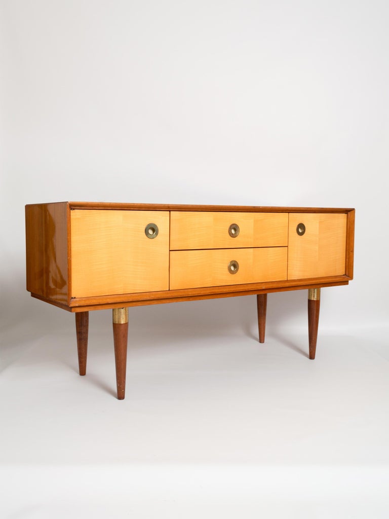 Midcentury mirrored dressing table in sycamore and walnut, France, circa 1950.
The vanity table has a large trifold mirror. Two central drawers flanked by a cupboard on either side, all with brass pull handles.
In very good vintage condition.