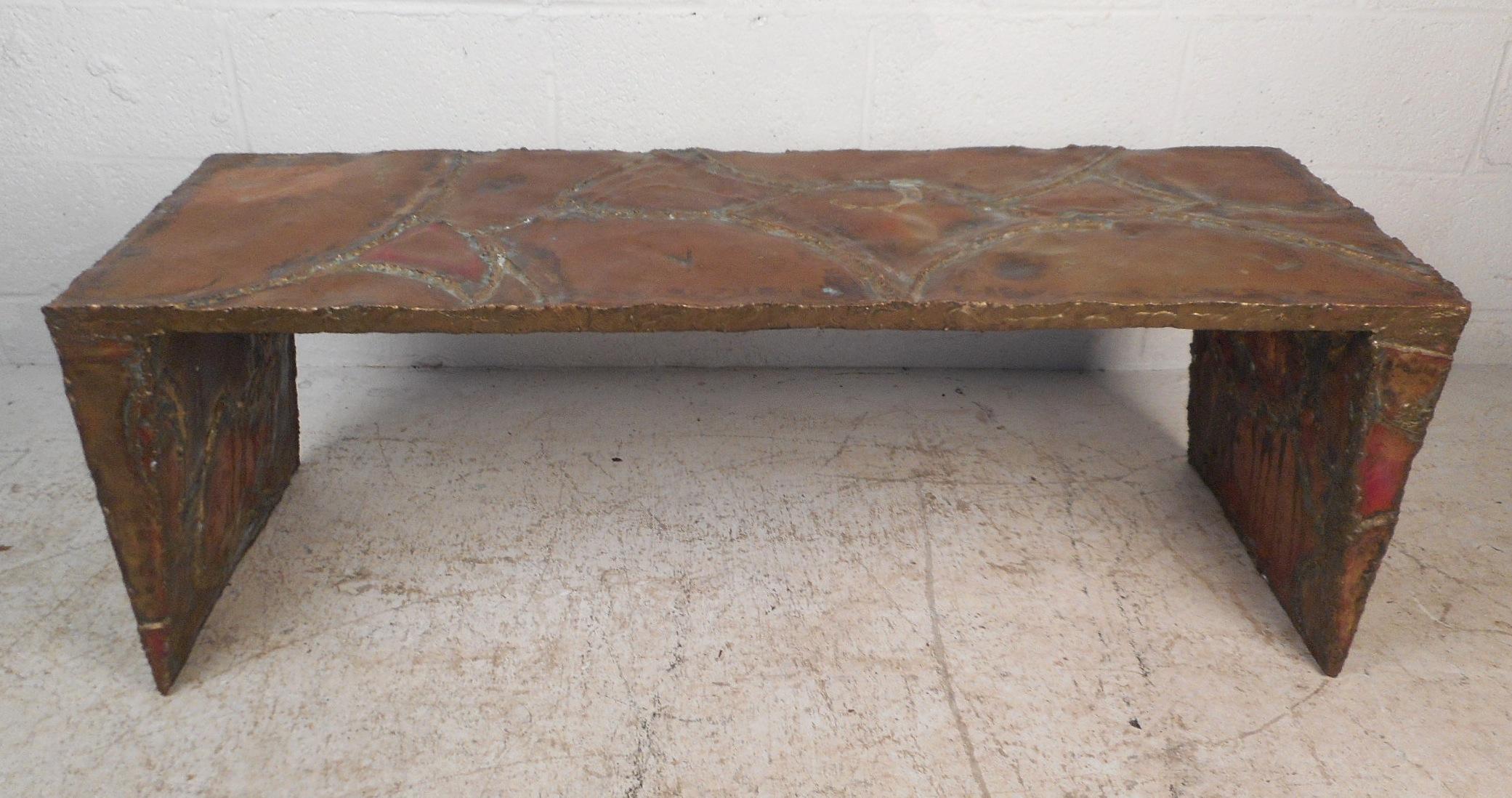 This beautiful vintage modern coffee table is signed by Silas Seandel, circa 1970s. A brutalist design that made of brass toned metals with gorgeous patina. The versatile shape with triangular legs allows this piece to fit perfectly in any setting.