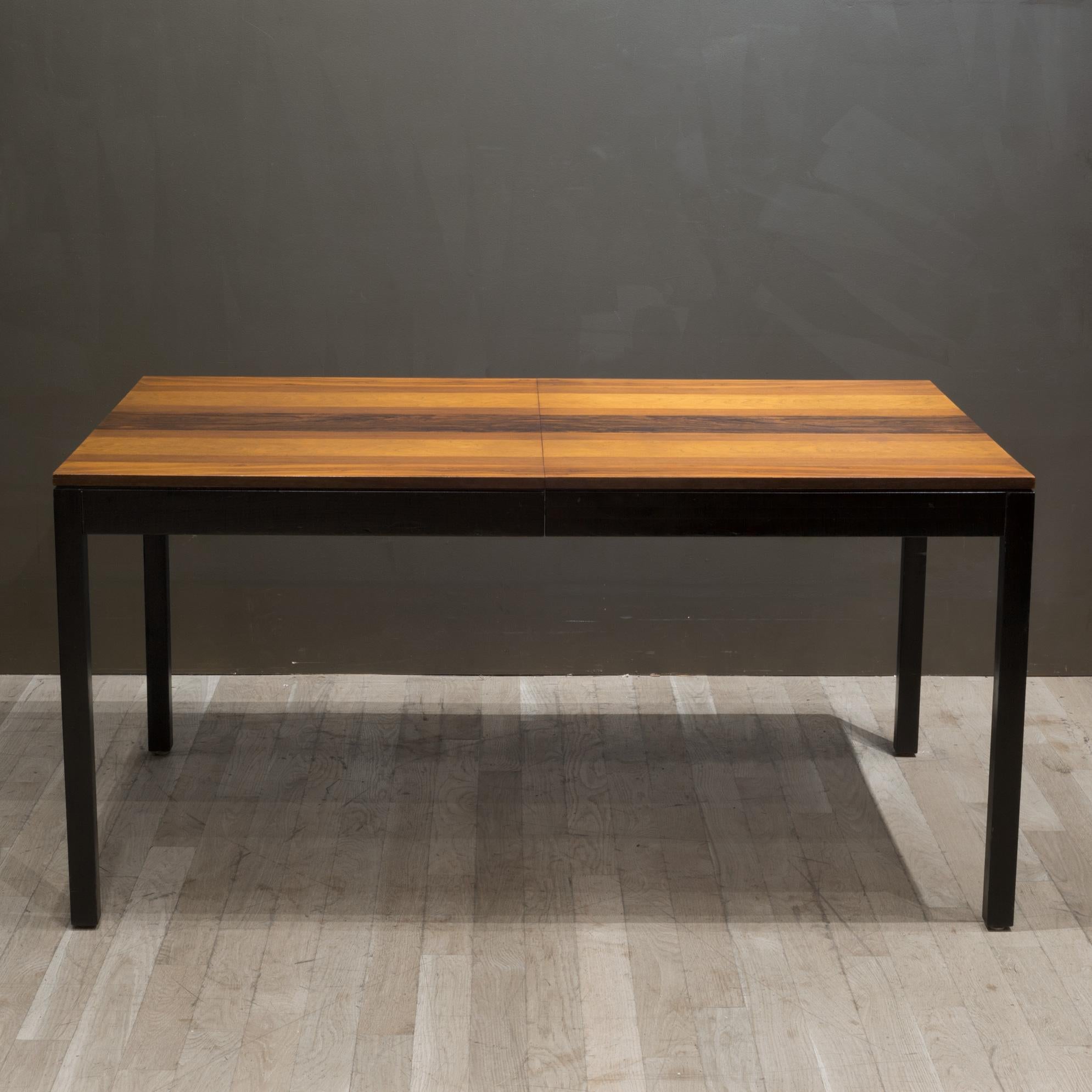 About

An original Milo Baughman Parsons dining table by Directional Furniture with a striped veneer top of Rosewood, Teak and Walnut over a black lacquer base. This dining table comes with one extension leaf to accommodate extra seating,