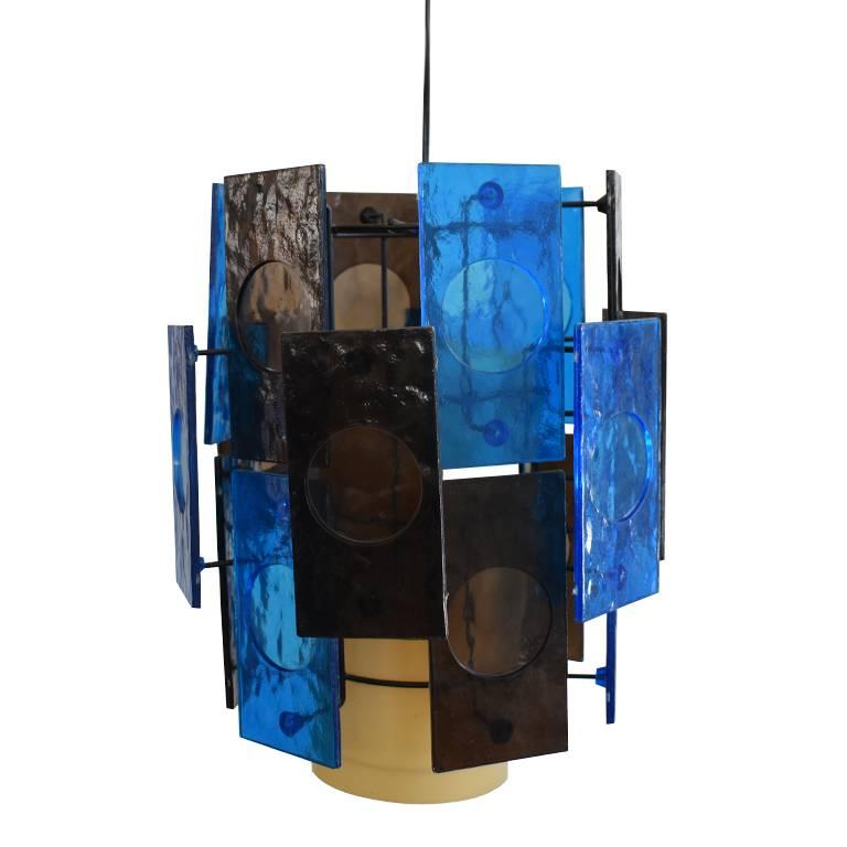 Mid-Century Modern blue and brown acrylic swag pendant lights. Each acrylic plate is affixed to a metal structure and surrounds a yellow drum shade. Each pendant contains one light and hangs from a black chain. These hard wired pendants would be a