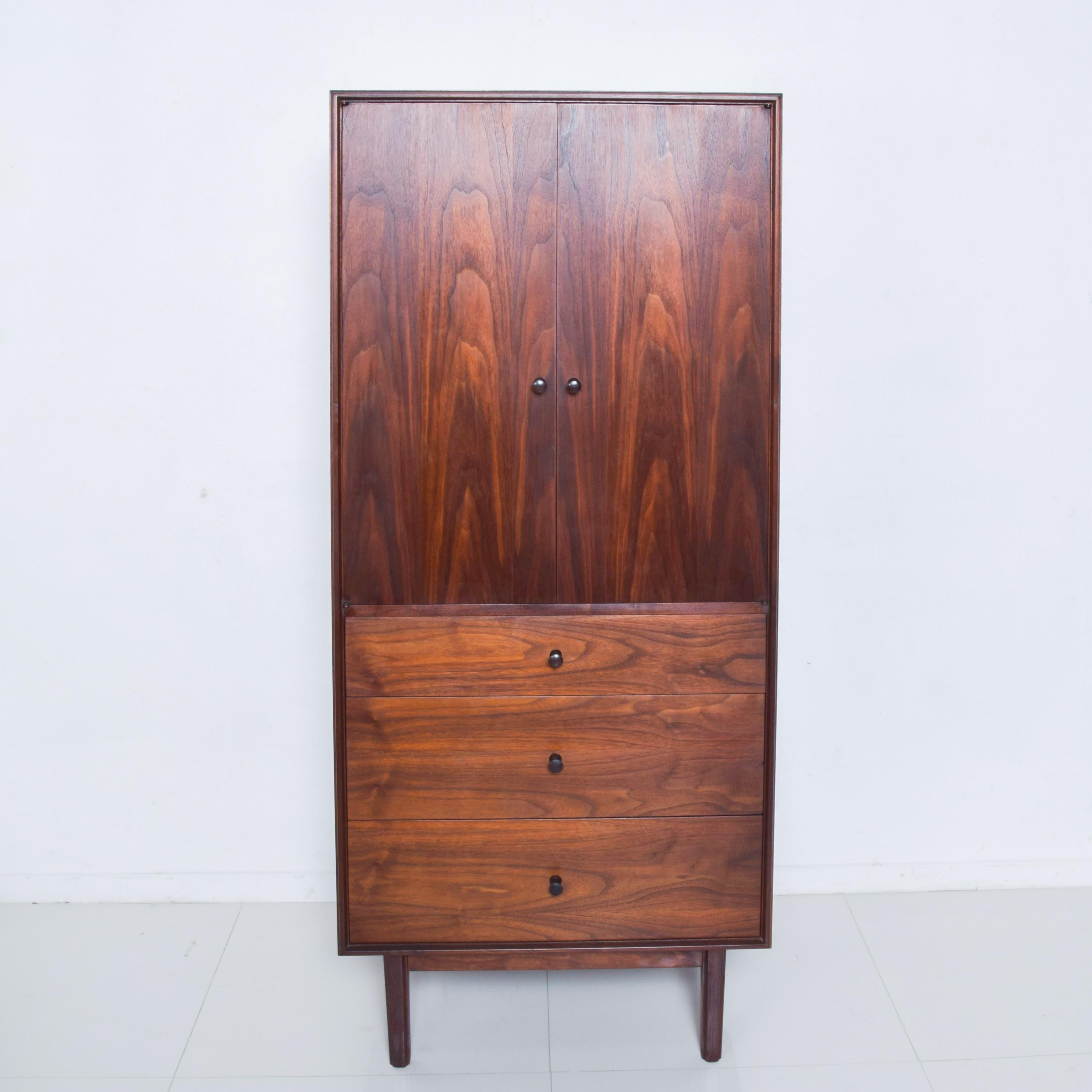 For your consideration, a beautiful and Classic Mid-Century Modern walnut tall cabinet with chest of drawers with rosewood handles.

Stamped with Glenn of California logo in upper drawer.

All drawers open a close with ease.

Made in the USA,