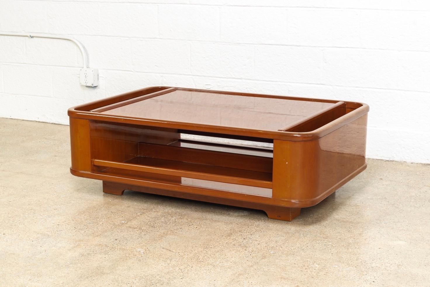 This vintage midcentury Italian coffee table circa 1970 has fabulous mod style. The Minimalist design features a low profile with clean geometric lines and rounded edges. It is well constructed from solid wood with a glossy lacquered enamel surface.