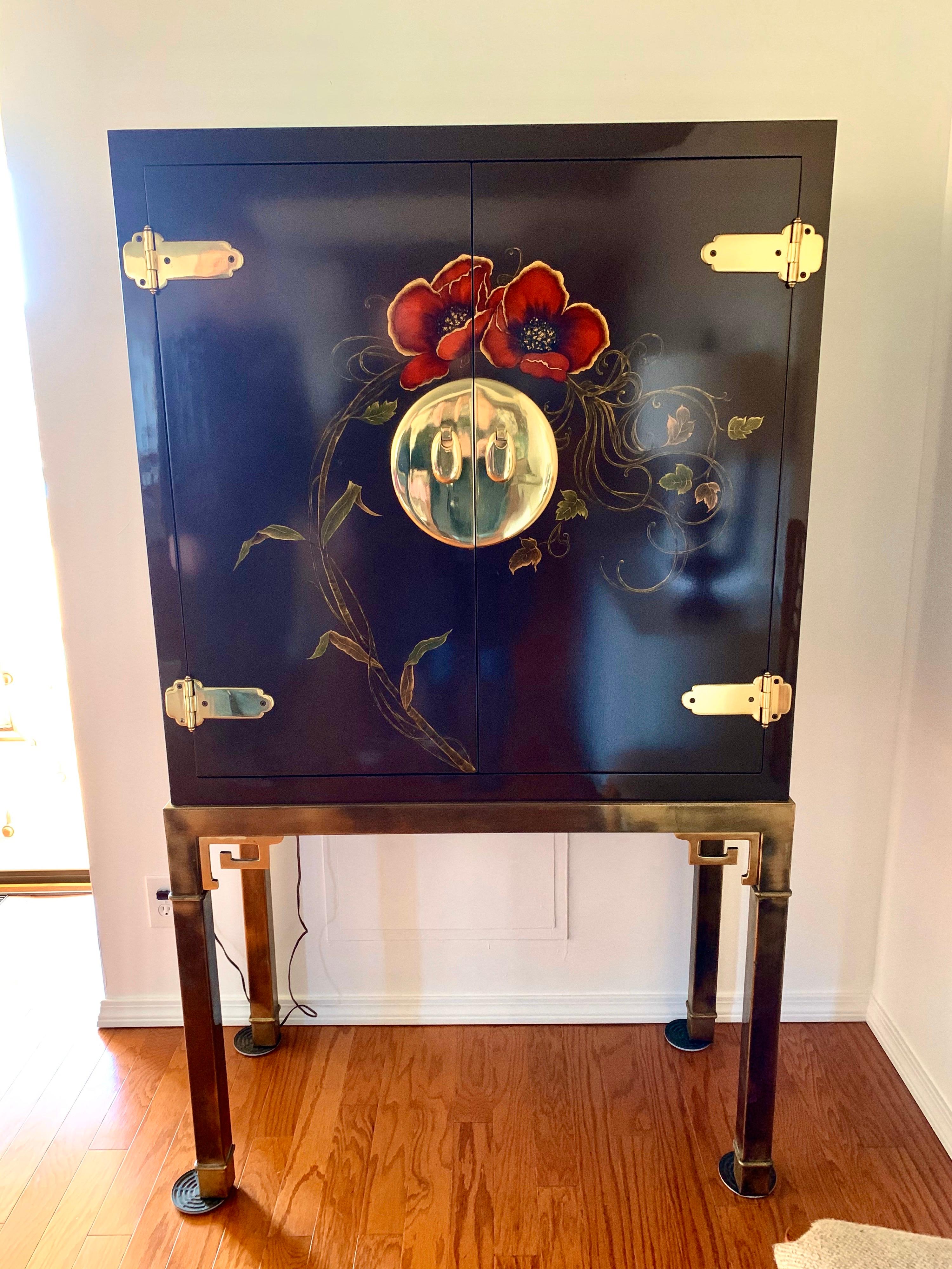 A coveted signed Mastercraft Classic, the mirrored bar cabinet which can also be used for entertainment system, etc. It has Greek key brass base and a lacquered top that looks like a work of art. What separates this piece from others is its