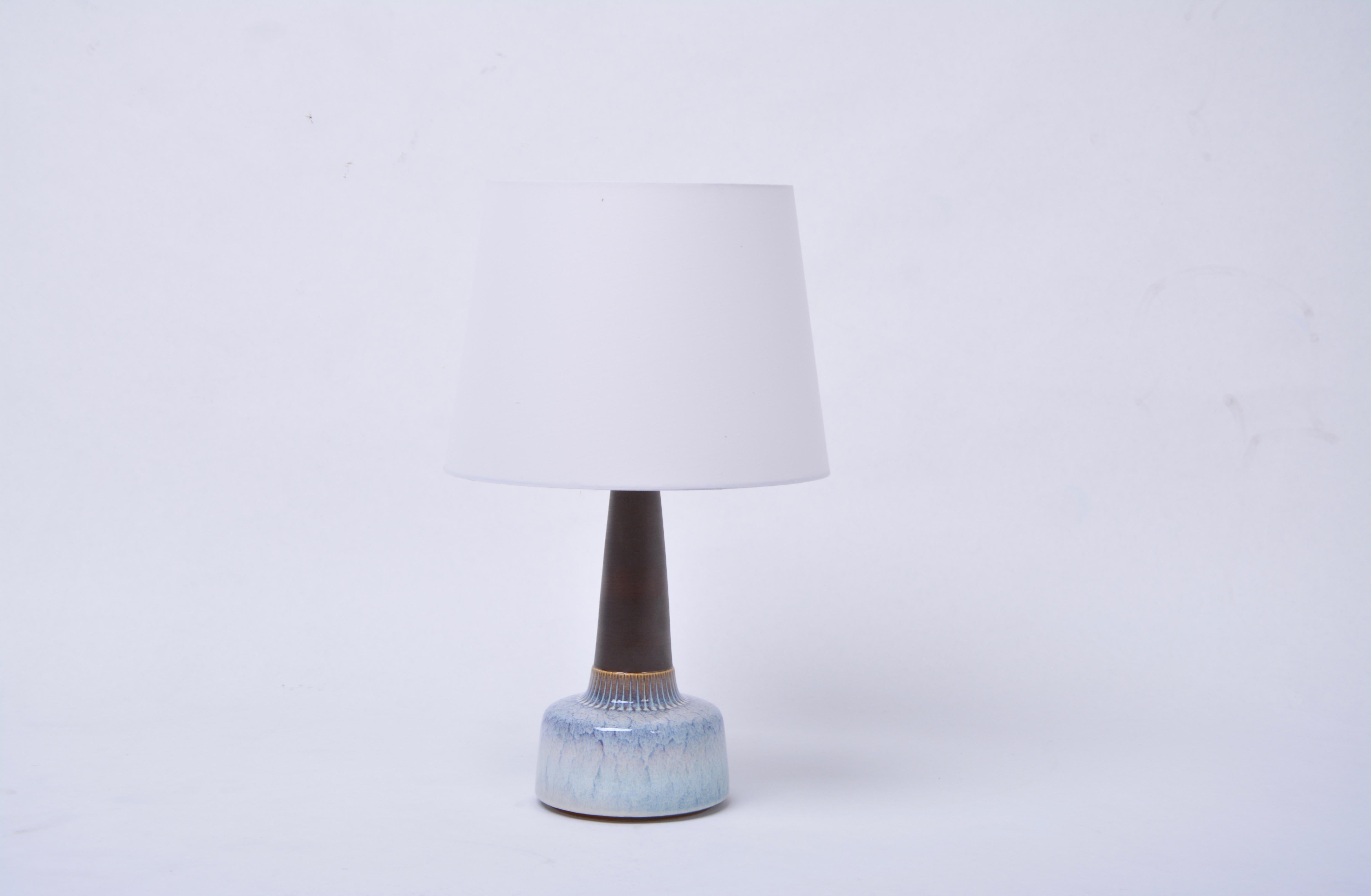 Pair of White Mid-Century Modern Ceramic table Lamps Model 941 by Soholm

Table lamp made of stoneware with light blue ceramic glazing to the base of the lamp. Designed by Einar Johansen and produced by Danish company Soholm. The lamp has been