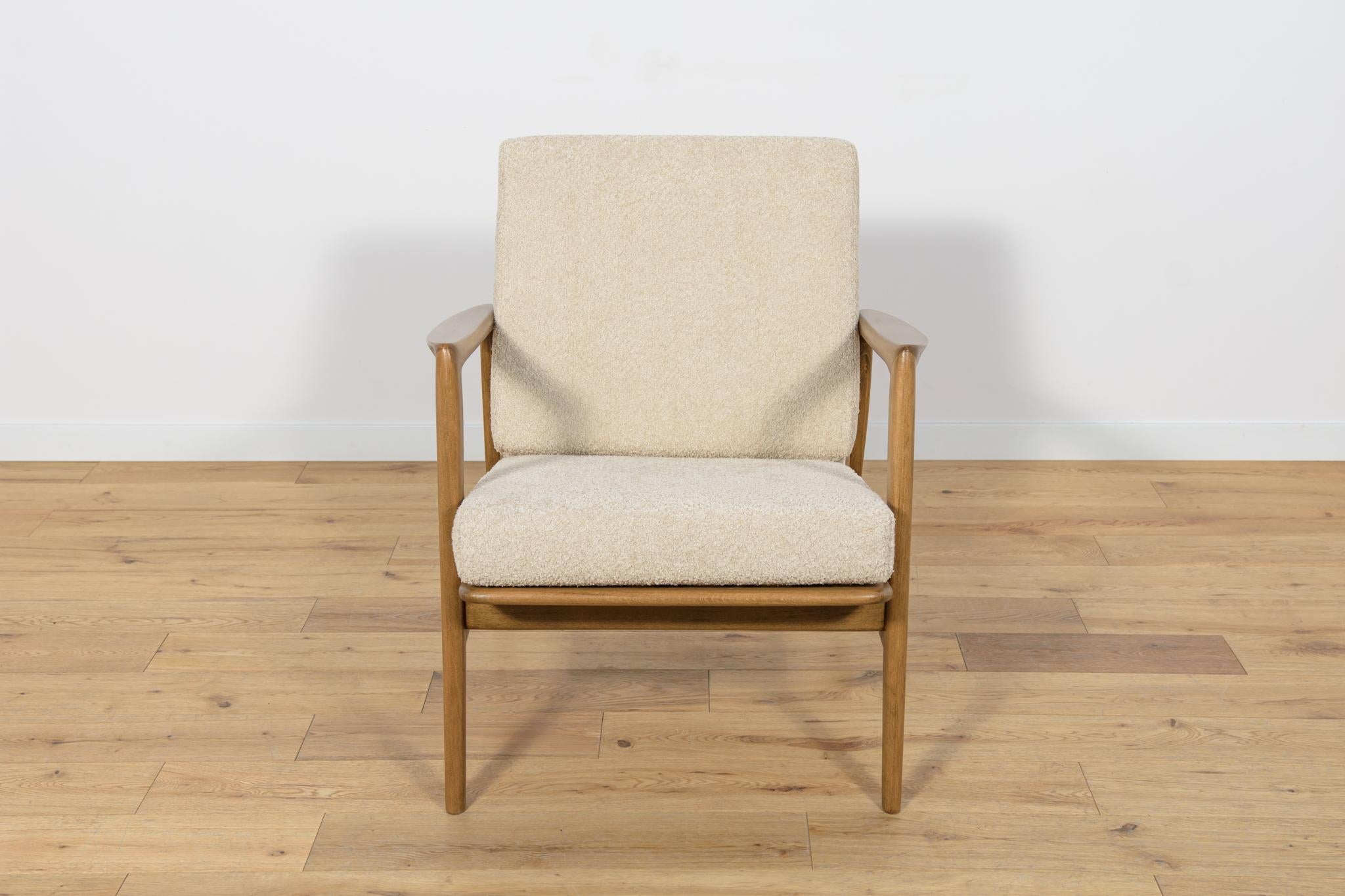 
The armchair was produced by the Polish company Swarzędzka Furniture Factory in 60s. Comfortable armchair with a unique form. Cushions replaced with new ones, upholstered in high-quality boucle typ fabric in a cream color. The beech frame has been