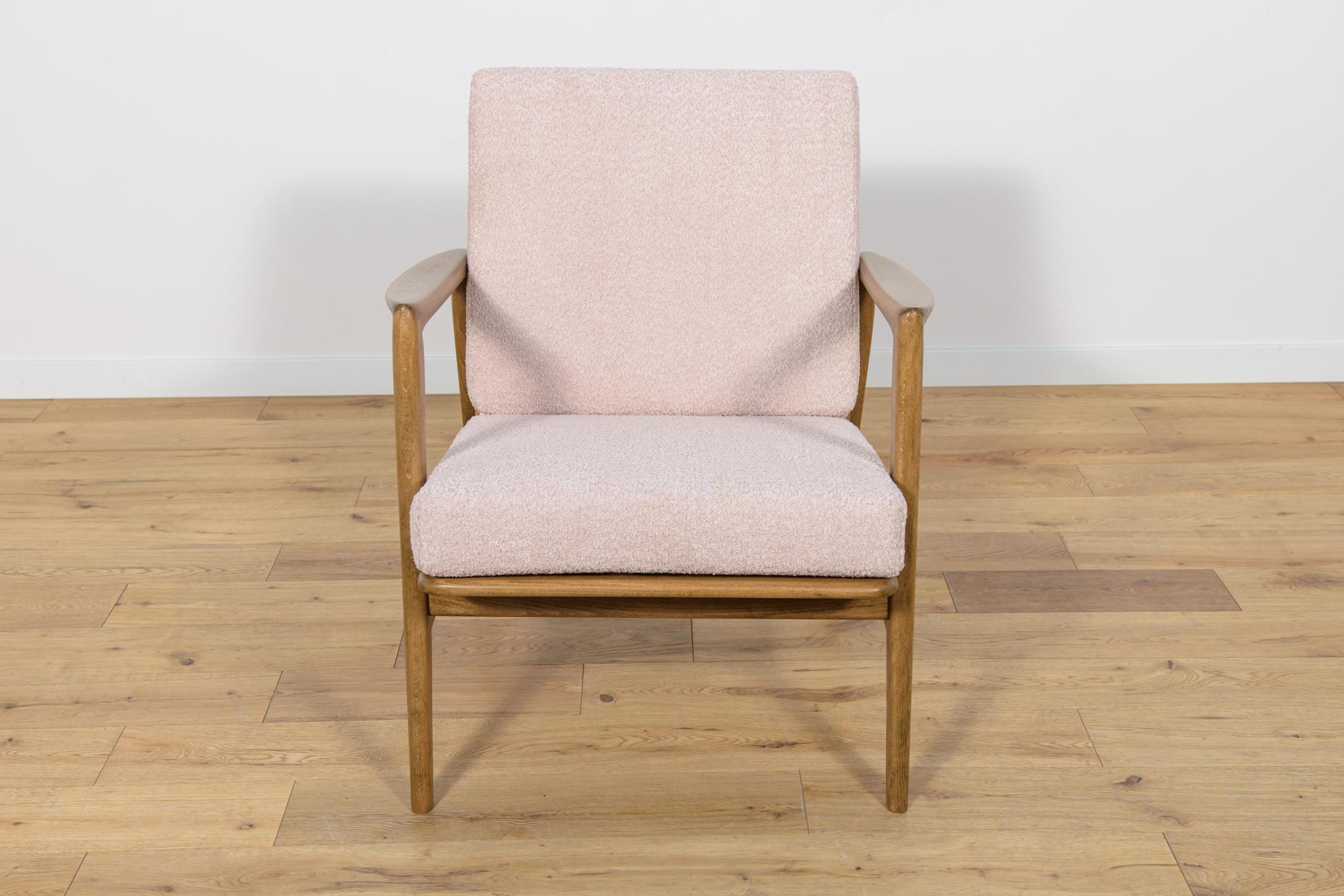 
The armchair was produced by the Polish company Swarzędzka Furniture Factory in 60s. Comfortable armchair with a unique form. Cushions replaced with new ones, upholstered in high-quality boucle typ fabric in a light pink color. The beech frame has