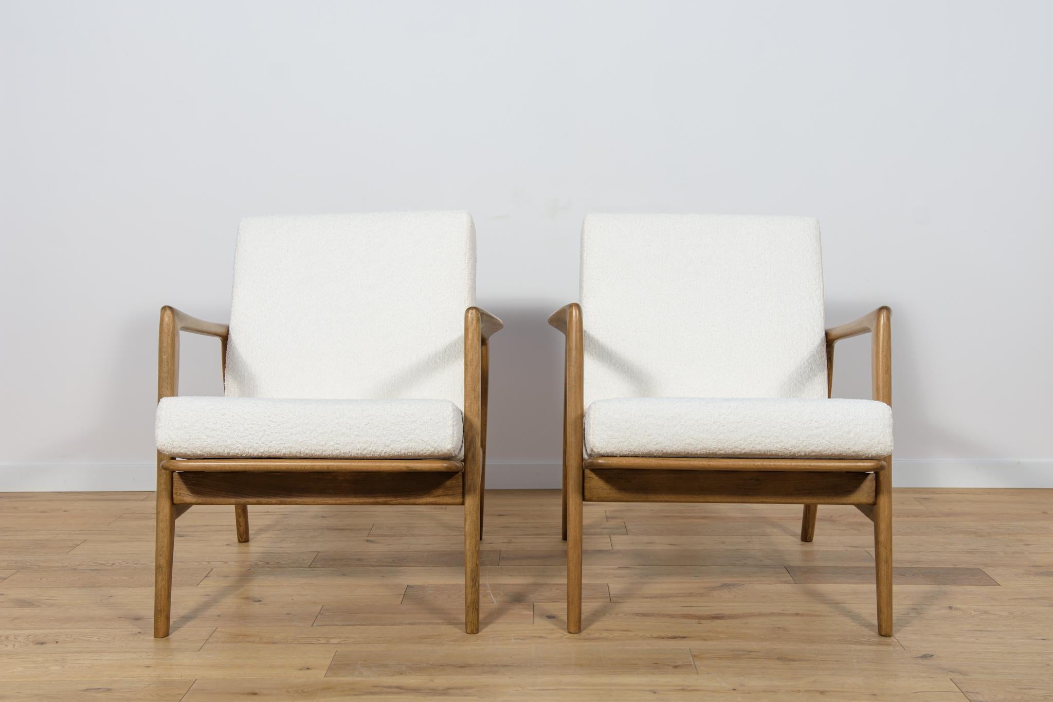 
This pair of armchairs was produced by the Polish company Swarzędzka Furniture Factory in 60s. Comfortable armchairs with a unique form. Cushions replaced with new ones, upholstered in high-quality boucle typ fabric in a white color. The beech
