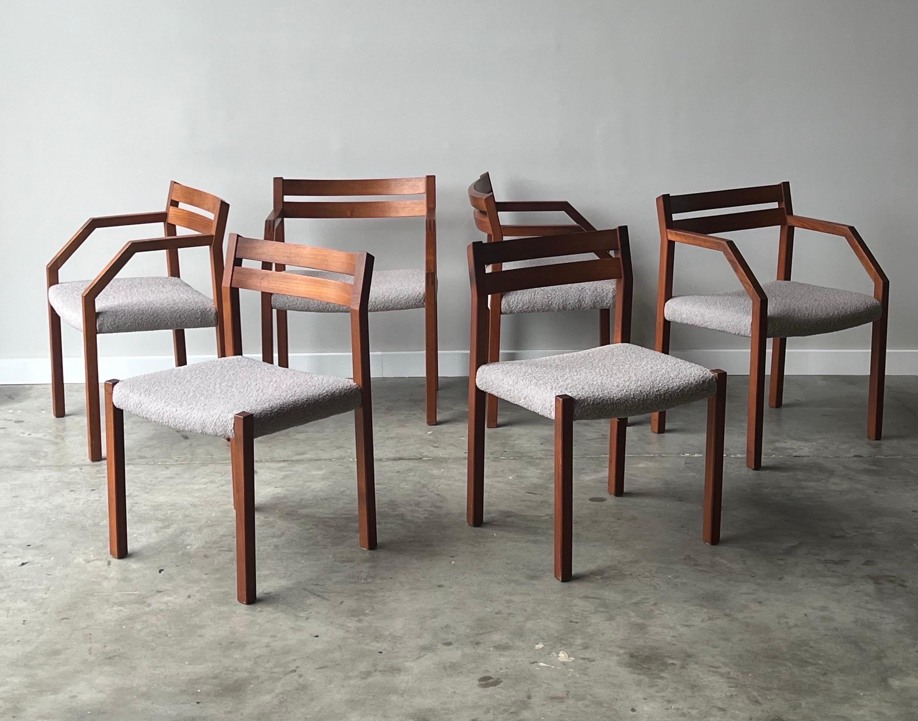 Mid-century Model 401 dining chairs designed by Niels Otto Møller for J.L. Møller, Denmark. The set of six chairs feature four armchairs and two without arms. The Model 401 chairs are made from sculpted teak and showcase excellent craftsmanship. The