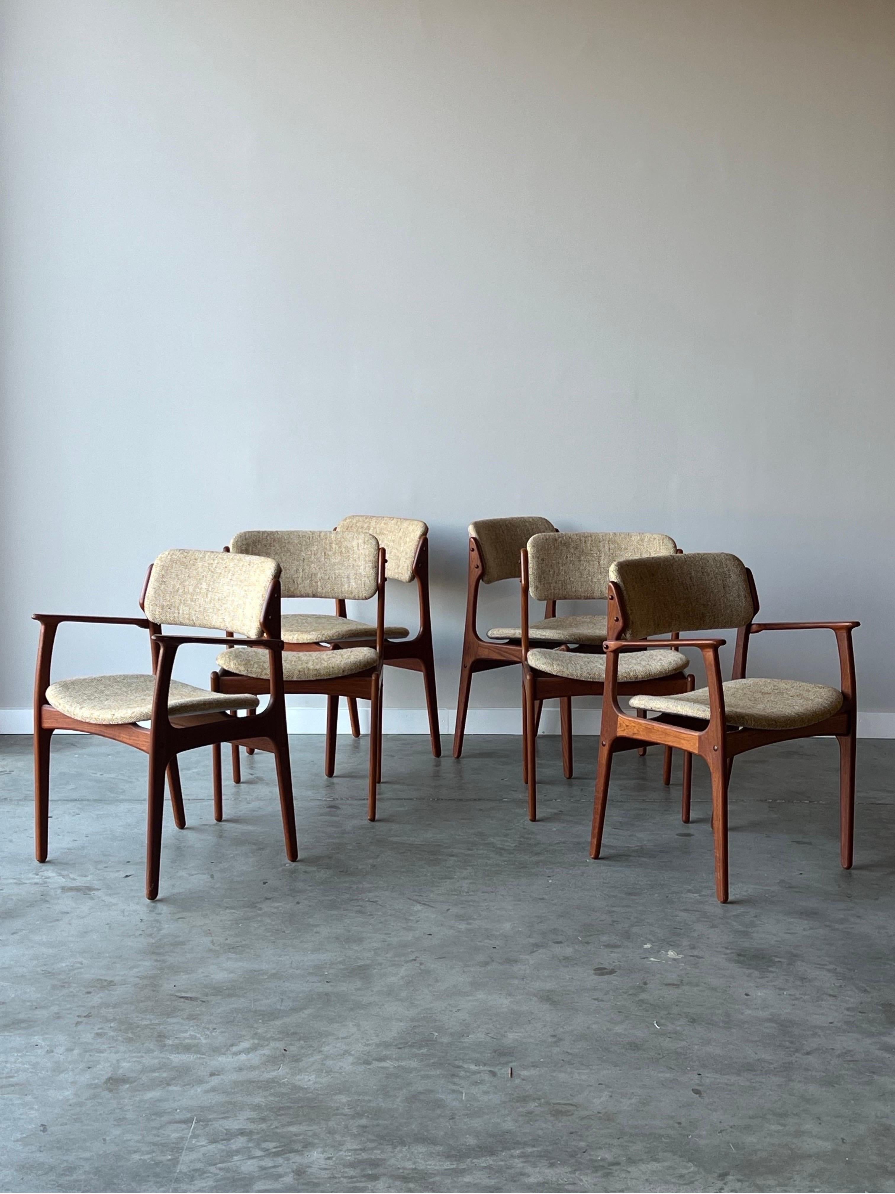 Mid-century teak Model 49 dining chairs. Designed by Erik Buch for O.D. Møbler, Denmark. This set of six offers two armchairs and four chairs without. The side profile on the Model 49 chairs is unmatched with its sleek appearance and perfectly