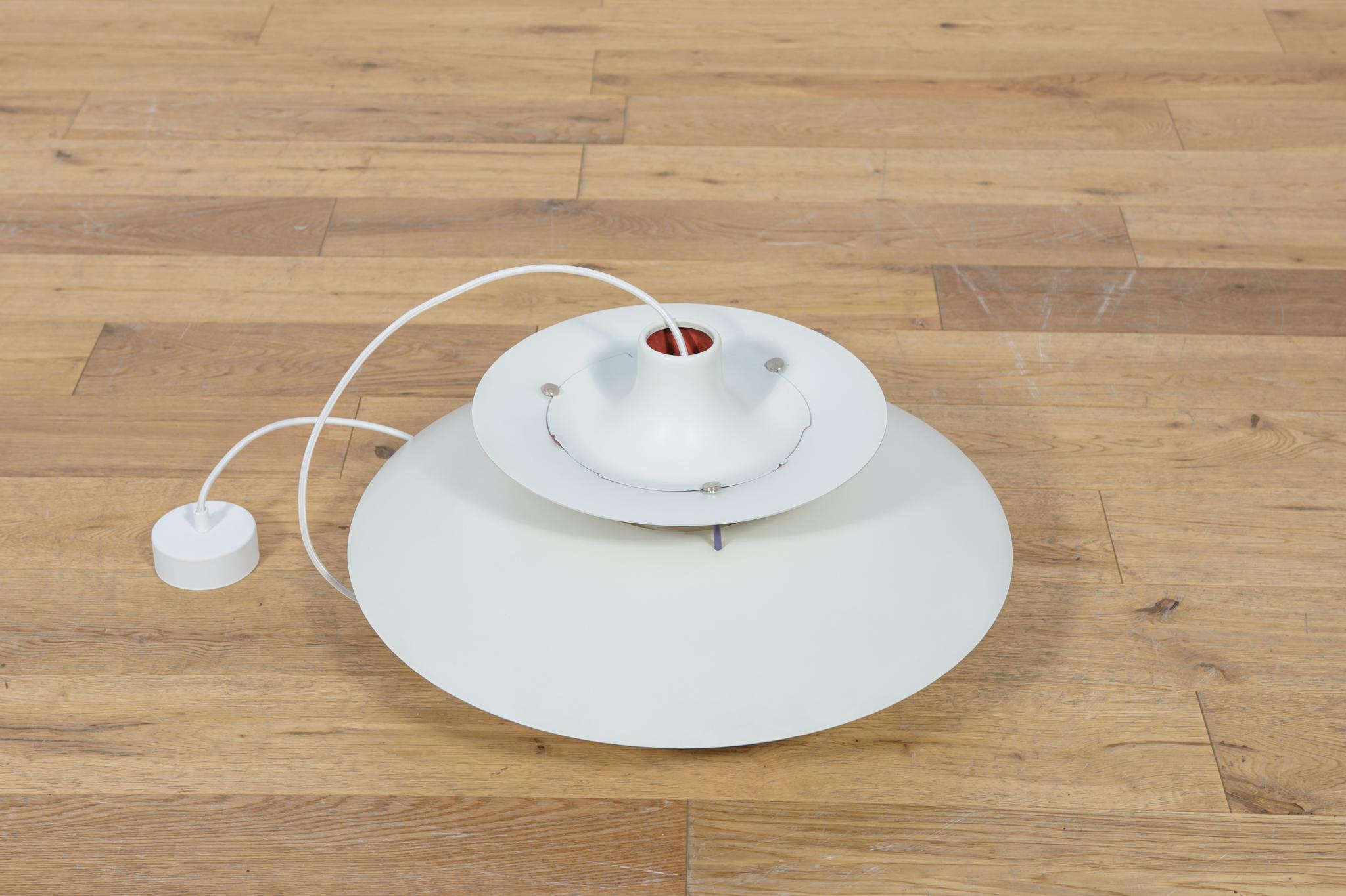 This is a Poul Henningsen's 1958 design based on the principle of a reflective three-shade system, which directs the majority of the light downwards. The PH5 lamp was launched in 1958: the 5 in its name refers to its 50 cm diameter. The shades are