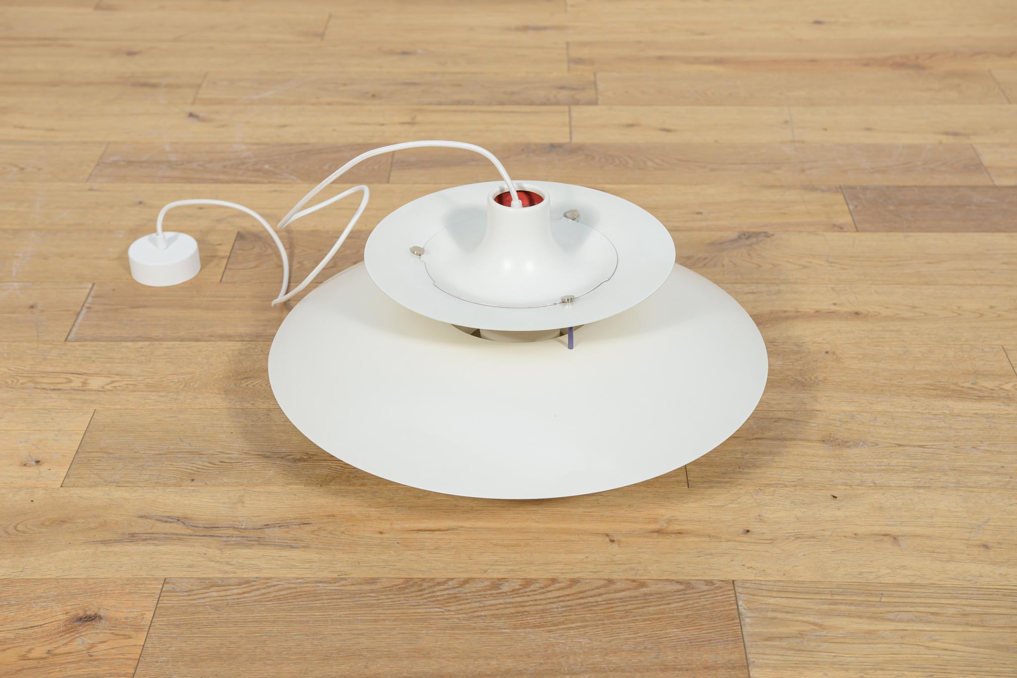 This is a Poul Henningsen's 1958 design based on the principle of a reflective three-shade system, which directs the majority of the light downwards. The PH5 lamp was launched in 1958: the 5 in its name refers to its 50 cm diameter. The shades are