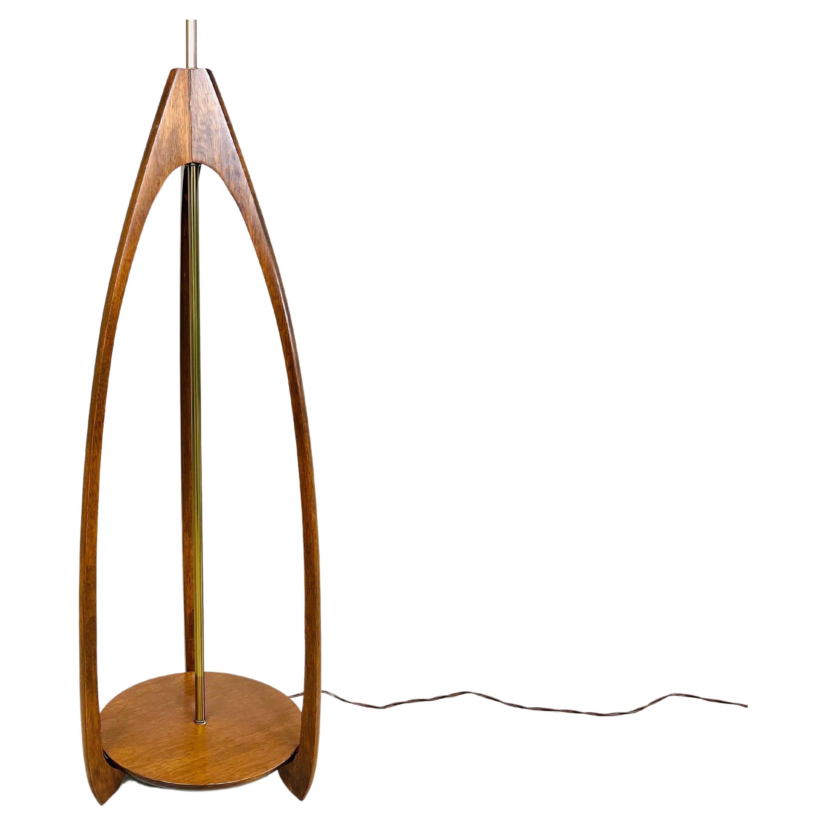 Tan France Auction Pick

A beautiful sculptural floor lamp by Modeline in the matter of Adrian Pearsall having walnut base with brass hardware. This piece is simple and elegant having an atomic design that was signature in the 1960s when it was