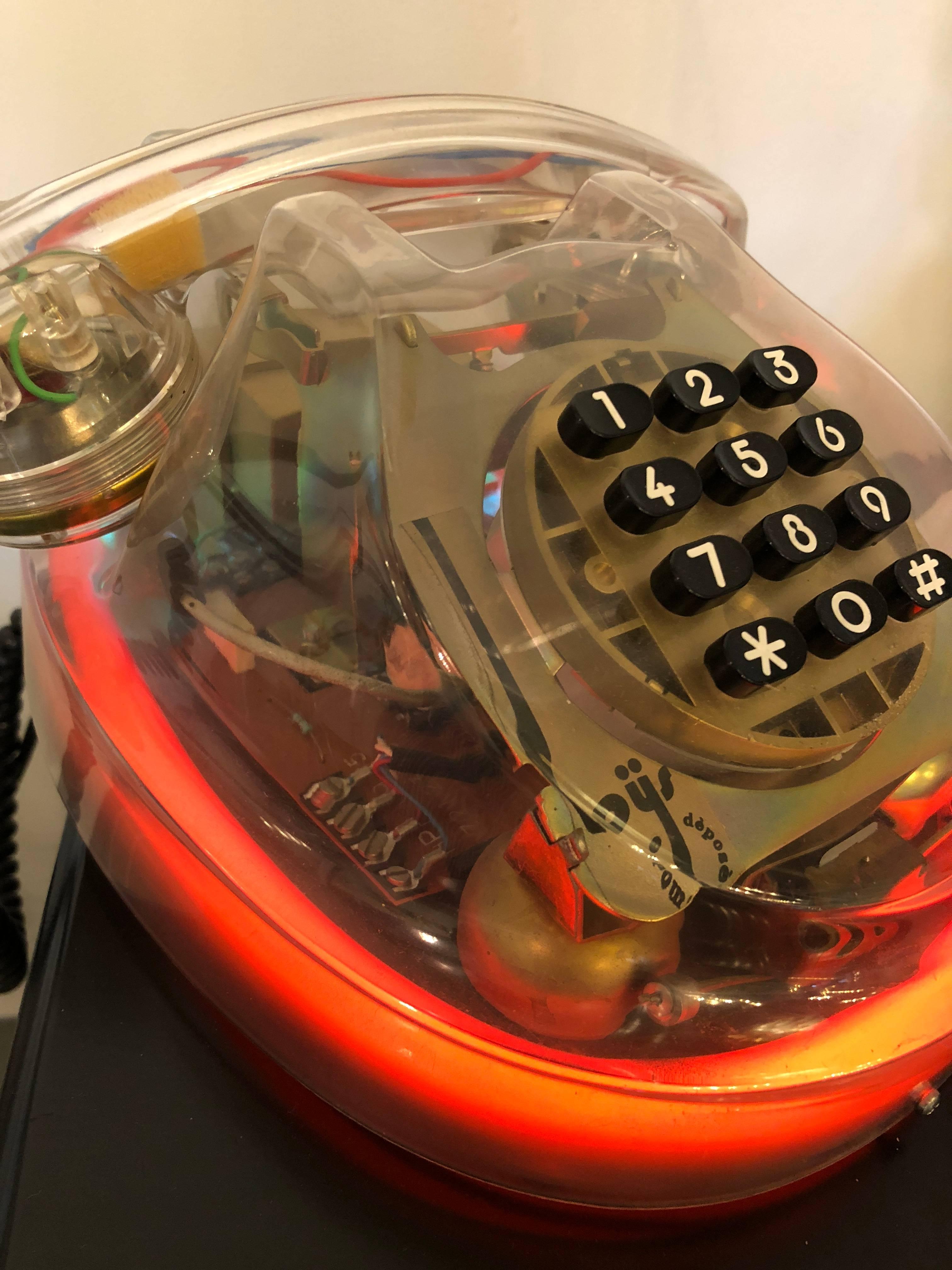 Offered is a Mid-Century Modern /Postmodern French Loys Lucite neon see through telephone. How much fun is this very mod Lucite phone made in France. Plug it in and it lights up with a neon red! Would make a great gift for a teen or young adult.