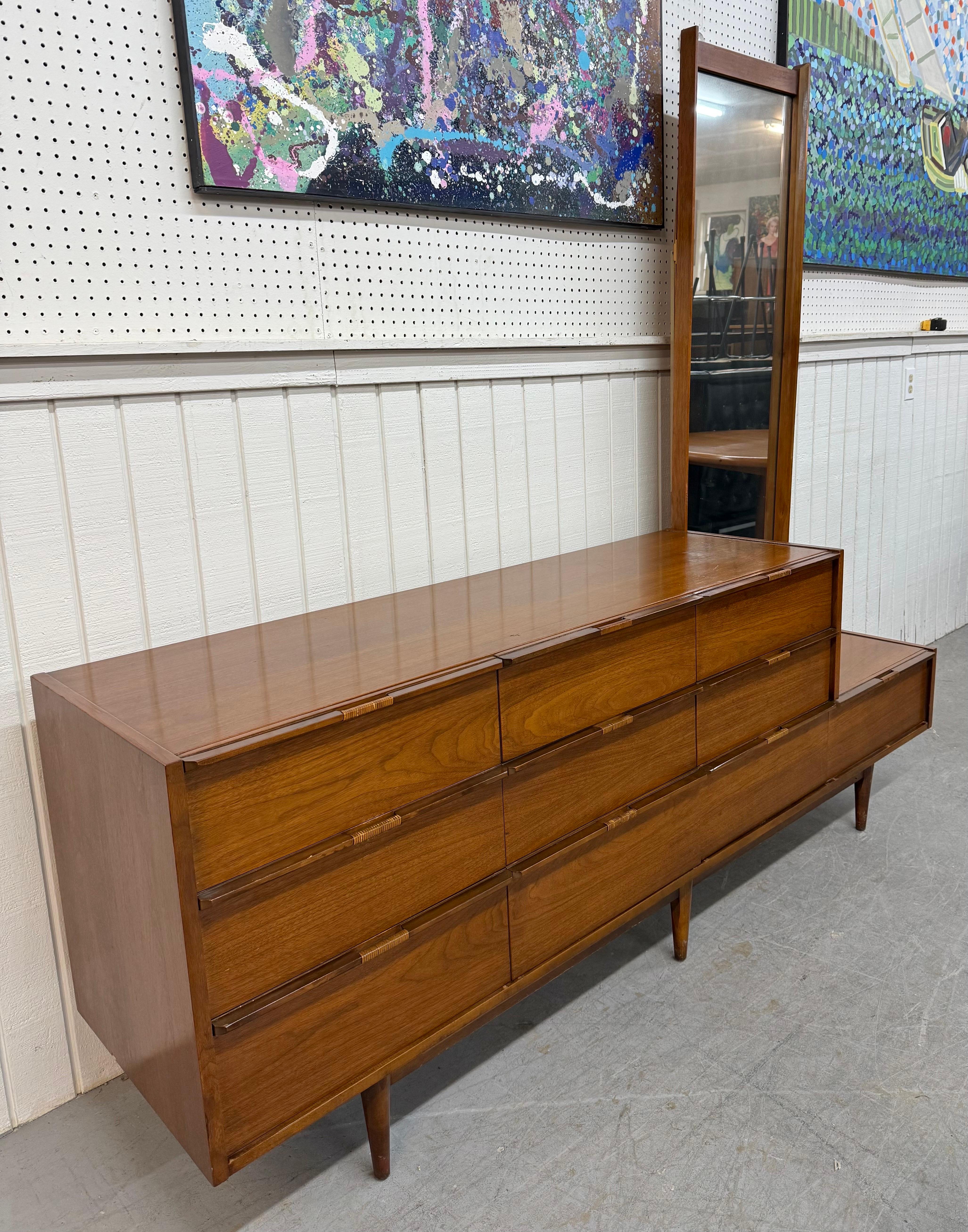 This listing is for a Mid-Century Modern 10-Drawer Walnut Dresser W/Mirror. Featuring a straight line design, ten drawers with wrapped pulls, long attached rectangular mirror, modern legs, and a beautiful walnut finish. This is an exceptional