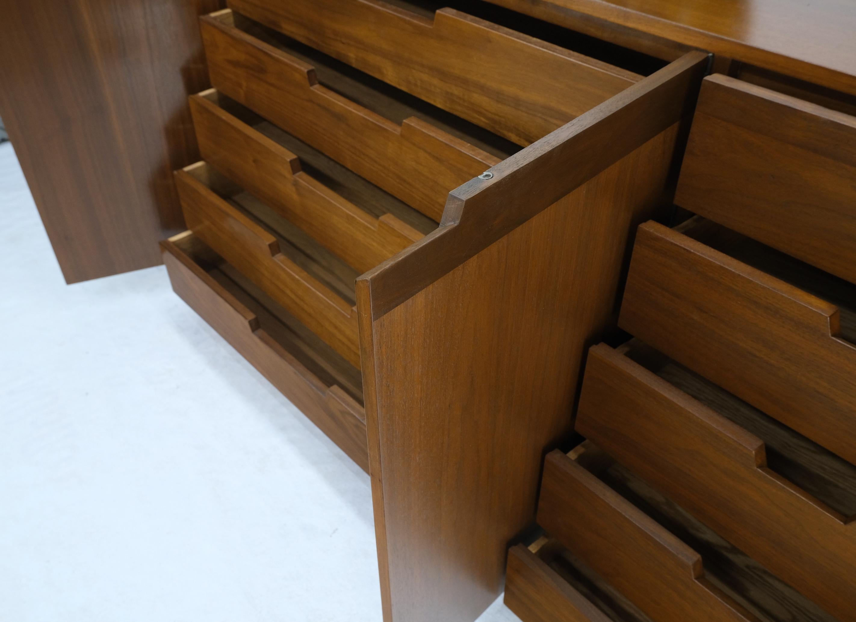 Fully restored Mid-Century Modern walnut credenza dresser with gallery top, 10 drawers and double doors compartment.