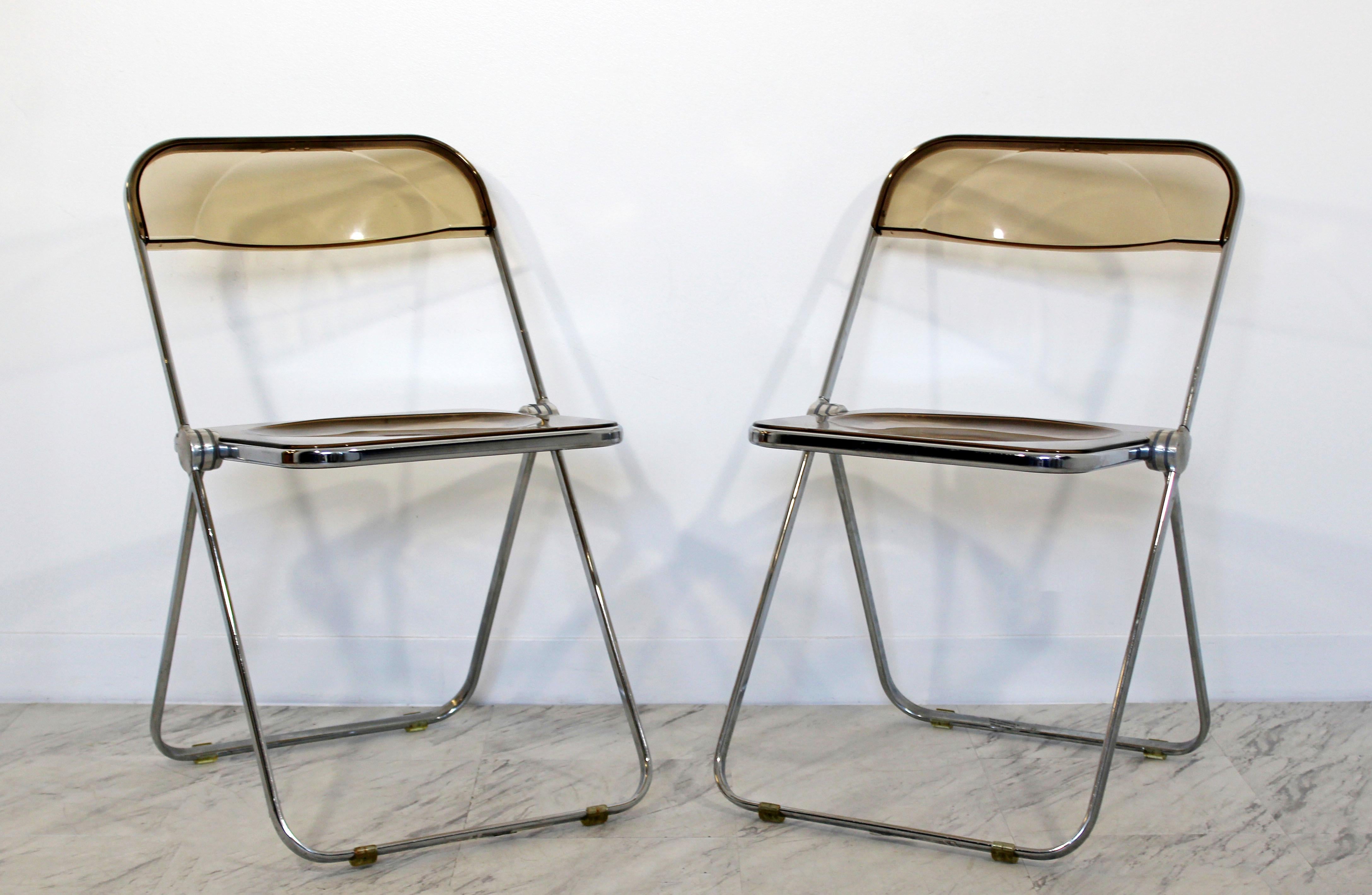 For your consideration is a wonderful set of ten folding chairs, made of chrome and smoked Lucite, by Castelli, made in Italy for Krueger, circa the 1960s. In good condition. The dimensions are 18.5