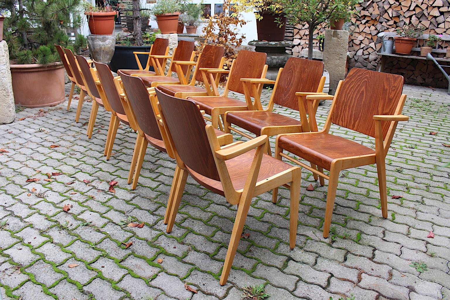 Mid Century Modern twelve ( 12 ) bicolor beech vintage armchairs or dining chairs by Franz Schuster for Wiesner - Hager 1959 Vienna.
An amazing and comfortable bicolor set of twelve dining chairs with armrests in wonderful soft brown color. While