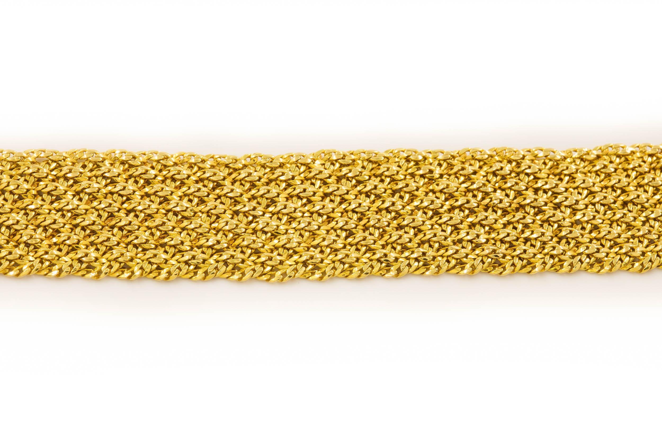 ESTATE 18 KARAT YELLOW GOLD FLEXIBLE-LINK STRAP BRACELET
Circa 3rd quarter of 20th century  7 7/8