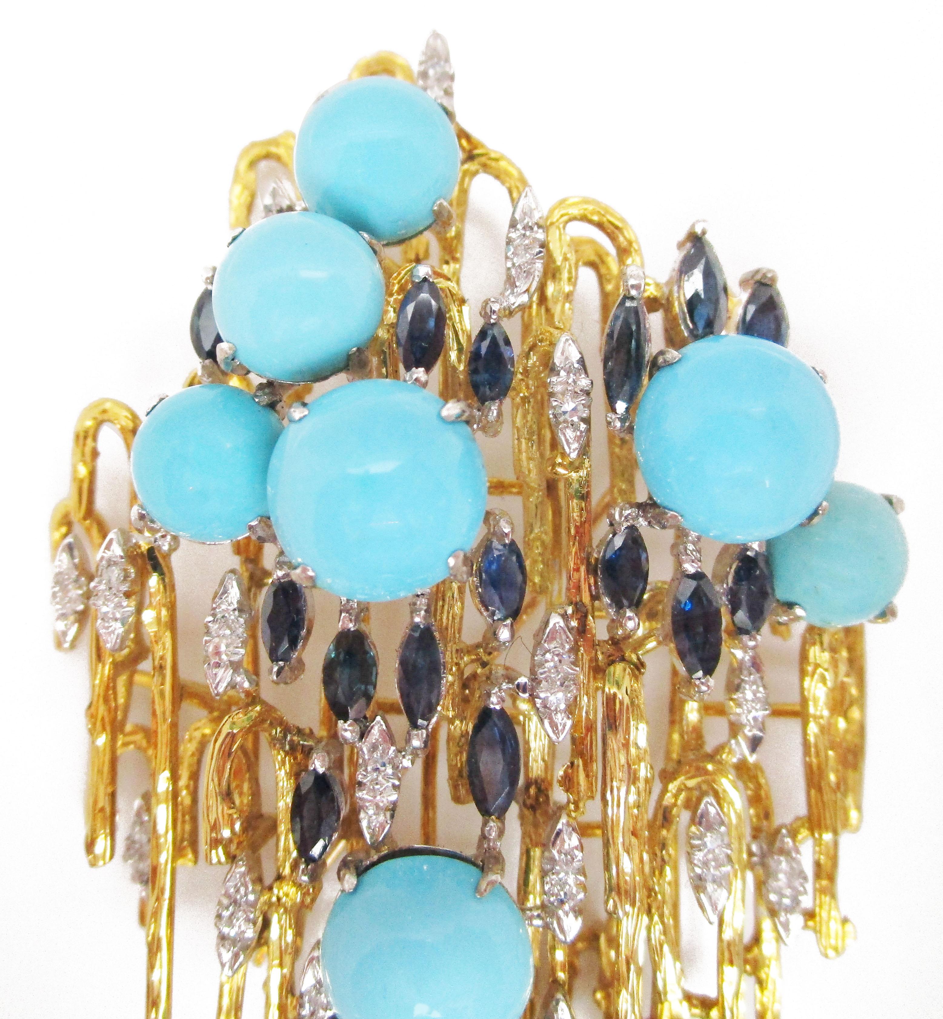 This stunning mid-century modern brooch combines rich 18k yellow gold, bright platinum, and a gorgeous array of Persian turquoise, diamond, and sapphire. The dimensional layout and unique design make this brooch something Madeleine Albright would