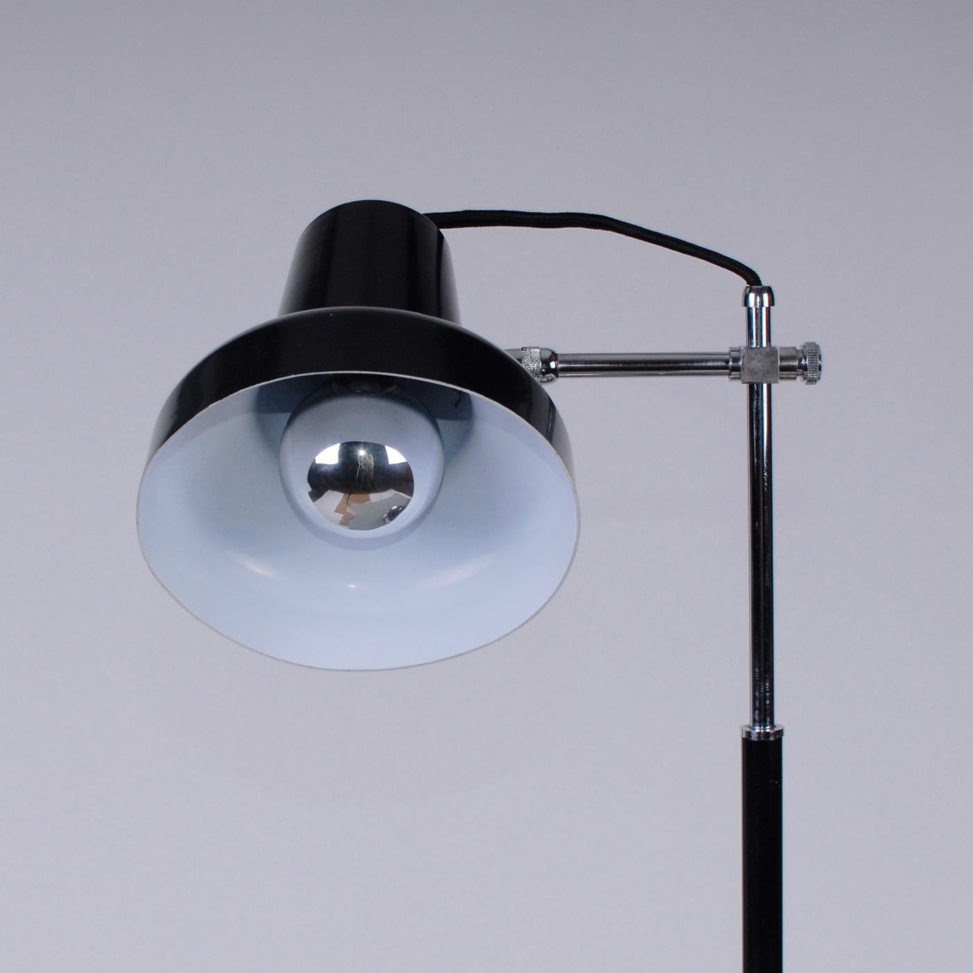 Mid-Century Modern 1950s black and chrome lacquered Italian desk lamp.
Chrome metal base with push switch black lacquer and chrome adjustable up and down rod, Aluminium black lacquered shade. Newly wired with fabric braided wire EU/US standard. E27