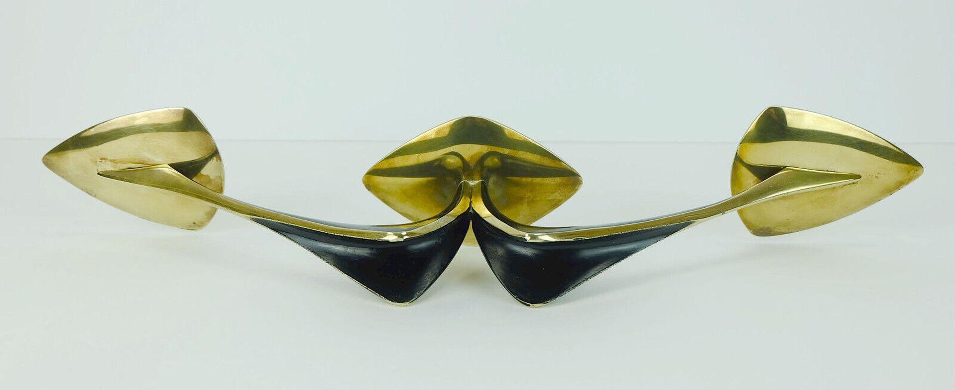 Mid-Century Modern candle holder designed by German goldsmith and Industrial designer Klaus Ullrich in 1958 and manufactured by Faber & Schumacher Duisburg. 
Made of brass, partially lacquered in matte black. Streamline design, a perfect addition