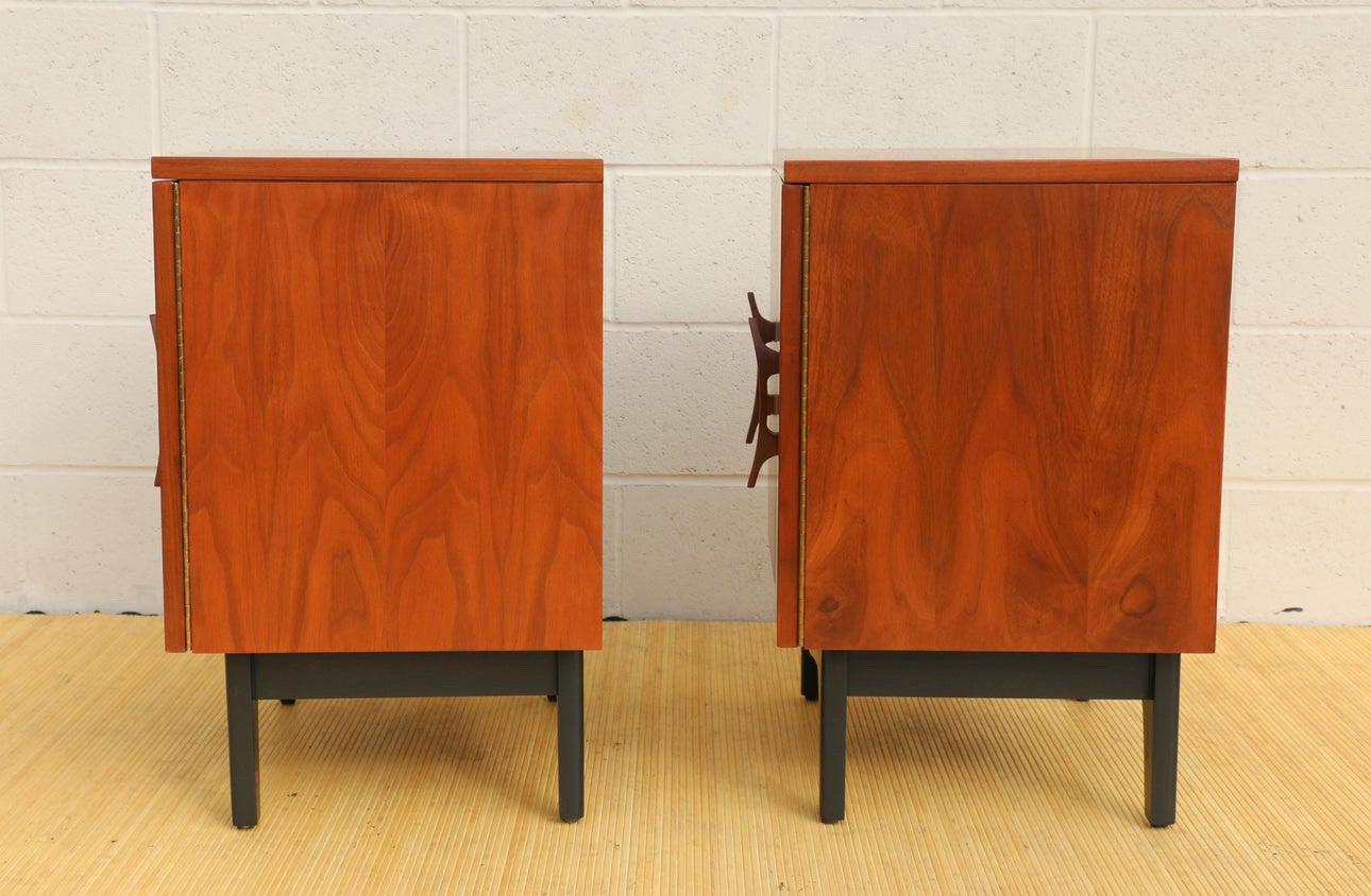 Wonderful pair of mid century nightstand from the 1960’s, made of walnut wood.  Very sturdy and durable. These nightstand have an amazing design, featuring some banana shape pull handles. They have enough space for storage, two doors and one shelf.