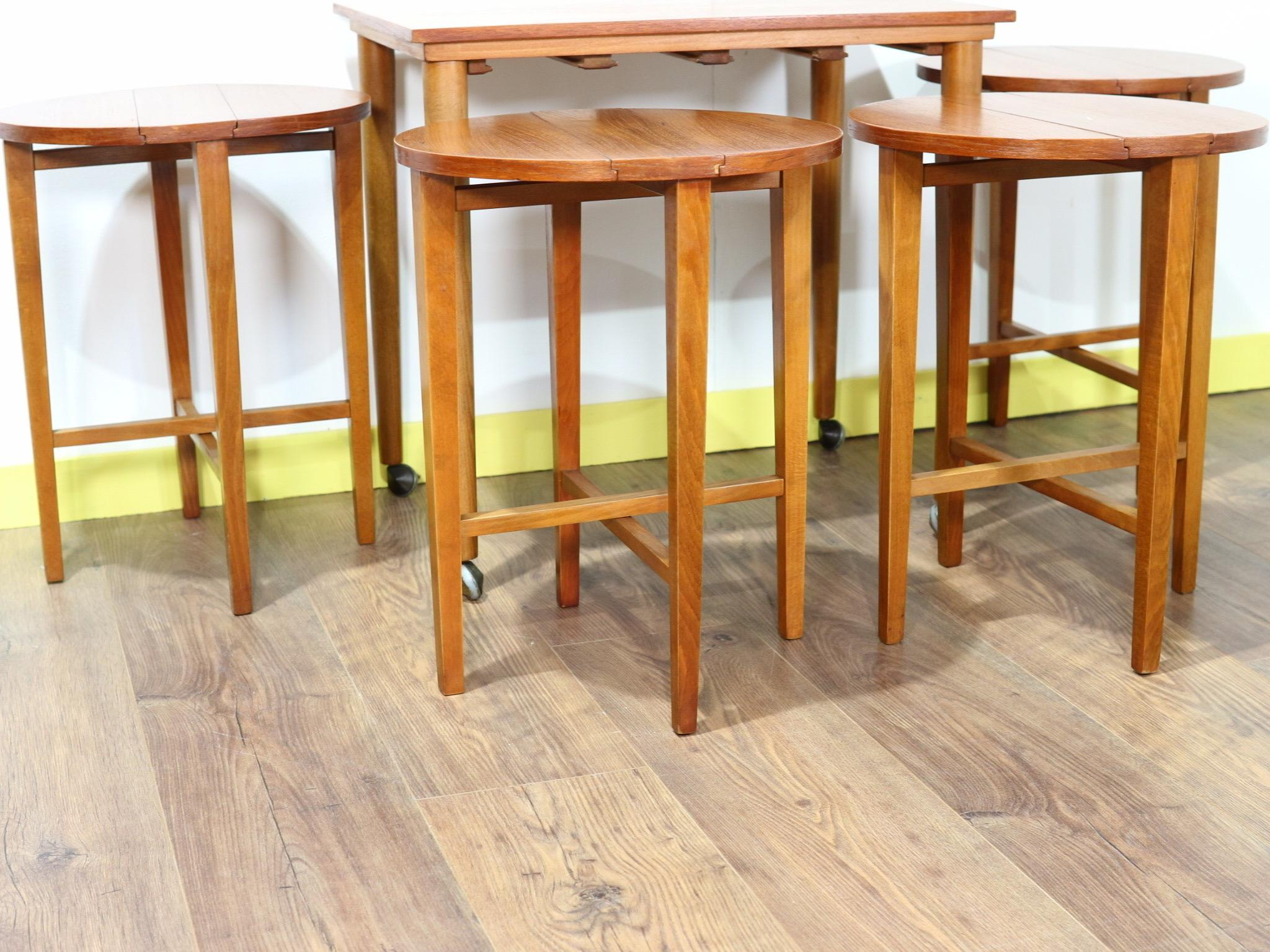 These 1960s Czechoslovakian nesting tables by Poul Hundevad are a really great design and idea. The main table houses 4 drop leaf tables that neatly fold up and slide underneath but offer plenty of table space when they are all unfolded


