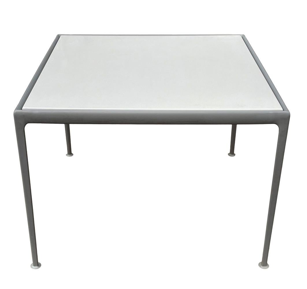 A classic outdoor patio dining table designed by Richard Schultz for Knoll. It features gray frame with white porcelain top. Clean ready to use condition.