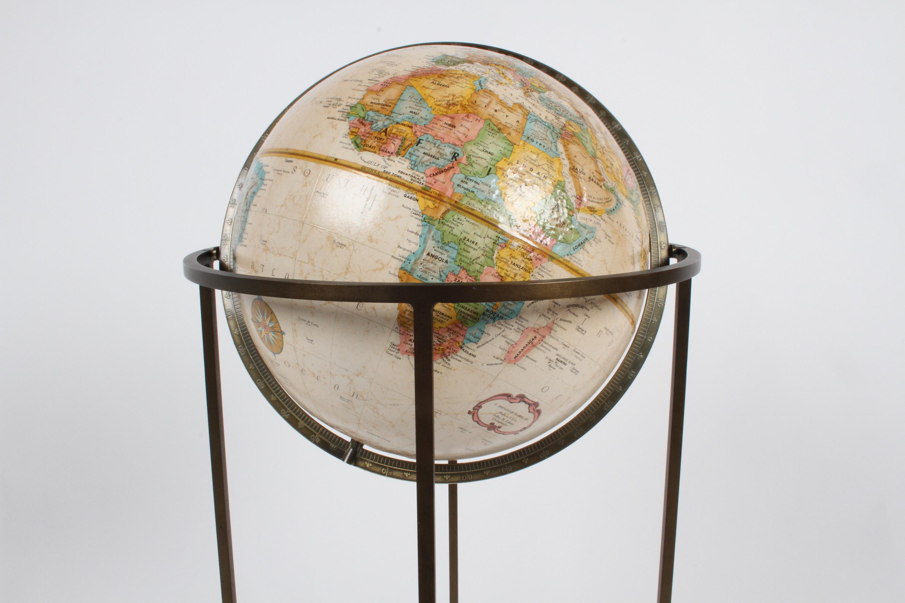 Often attributed to Paul McCobb, because of the same brass tubing that McCobb used in his furniture. 
This 1970s Replogle globe is in very nice condition with raised topography and the brass has a wonderful patina. Globe model is 12 inch Diameter