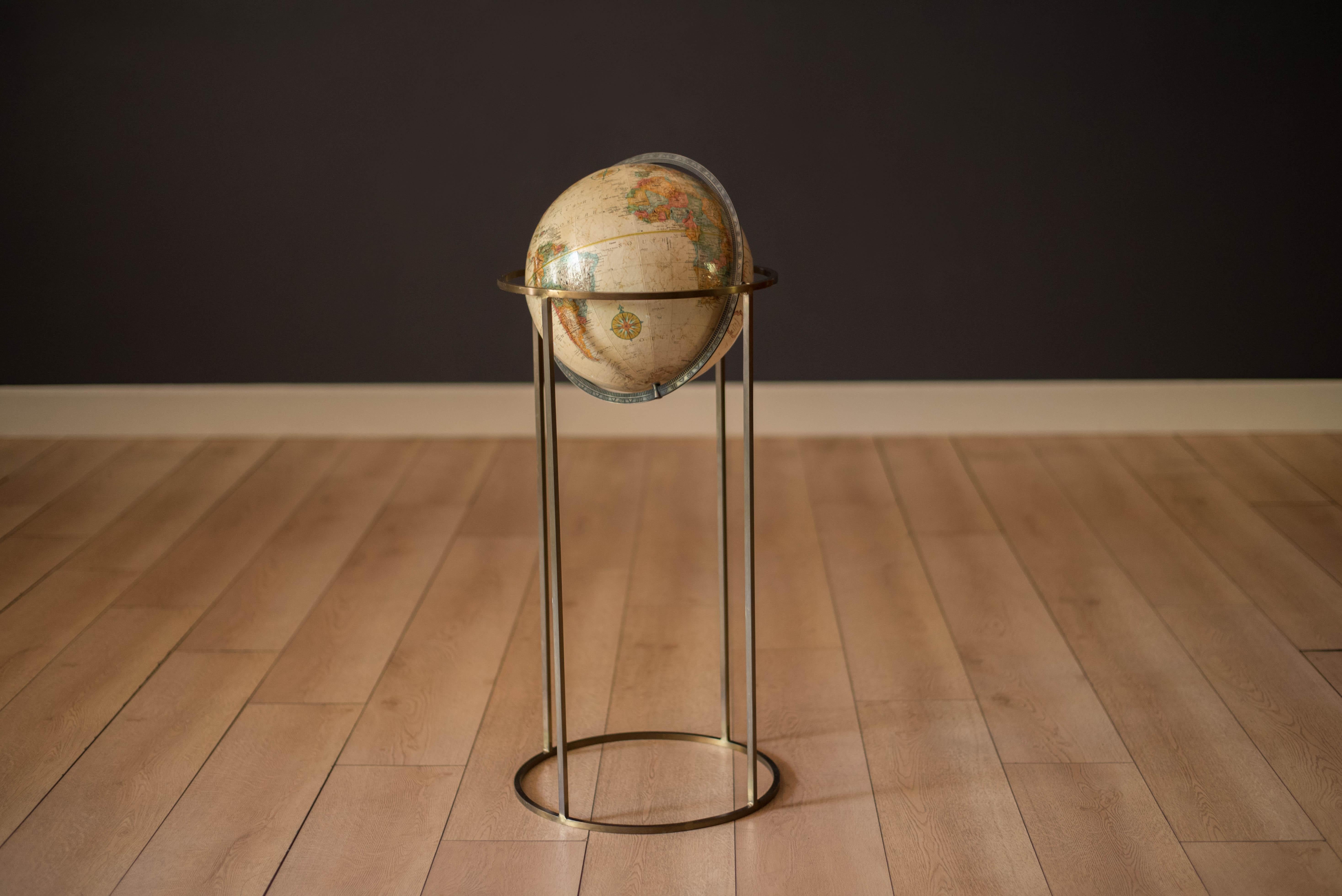 Vintage world map Replogle globe with stand in brass, circa 1970's. This piece rotates on a full swing meridian and displays plenty of vintage charm. The perfect accessory piece for any home office or library room.