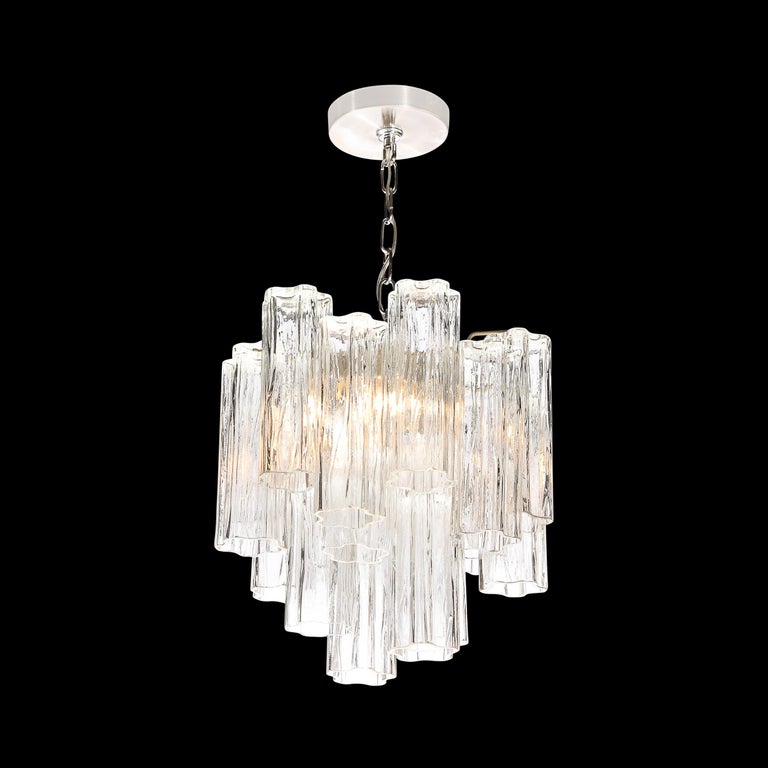This elegant and graphic Mid-Century Modern chandelier was realized in Murano, Italy- the island off the coast of Murano renowned for centuries for its superlative glass production- circa 1970. It features a drum form consisting of two vertical