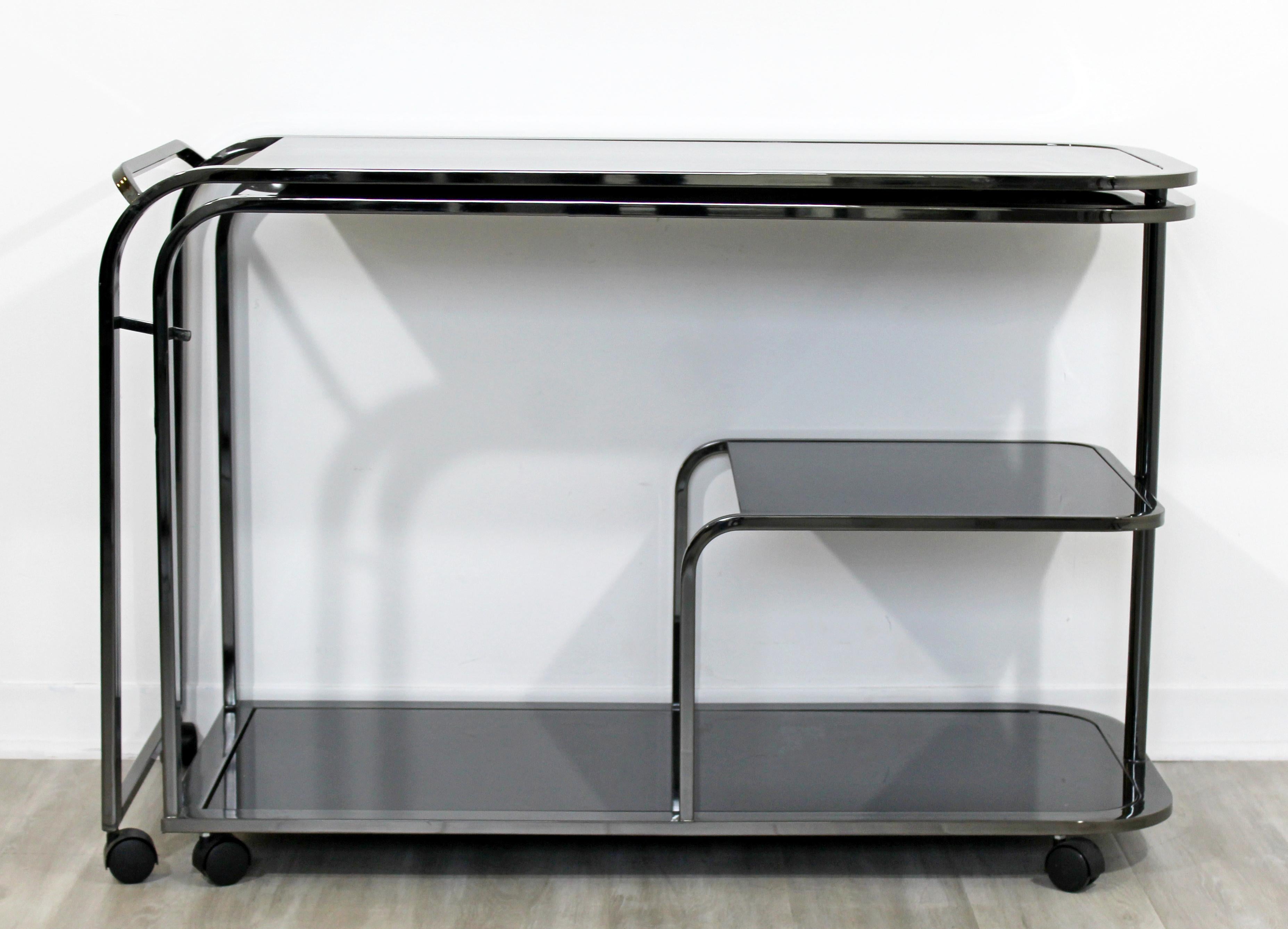 For your consideration is an incredible, expandable, rolling bar or service cart, with three glass tops, by The Design Institute of America, circa the 1970s. In excellent vintage condition. The dimensions are 45