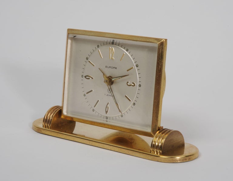 A 20th century stylish midcentury desk clock in gilded brass, articulated on a nicely weighted base. It has a good 8 day Jewelled movement which is fully working and tested. Has alarm function.