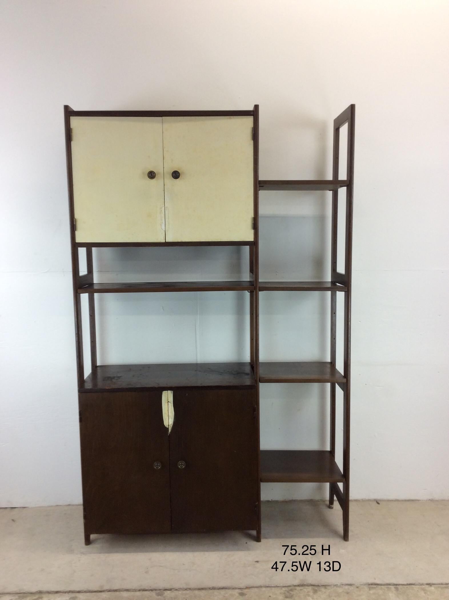 This mid century modern two piece modular shelving unit features hardwood construction, free standing two piece design, full interchangeable cabinet & shelving locations, finished back, and tapered legs.

Dimensions: 106.5w 13d 75.25h 

Condition: